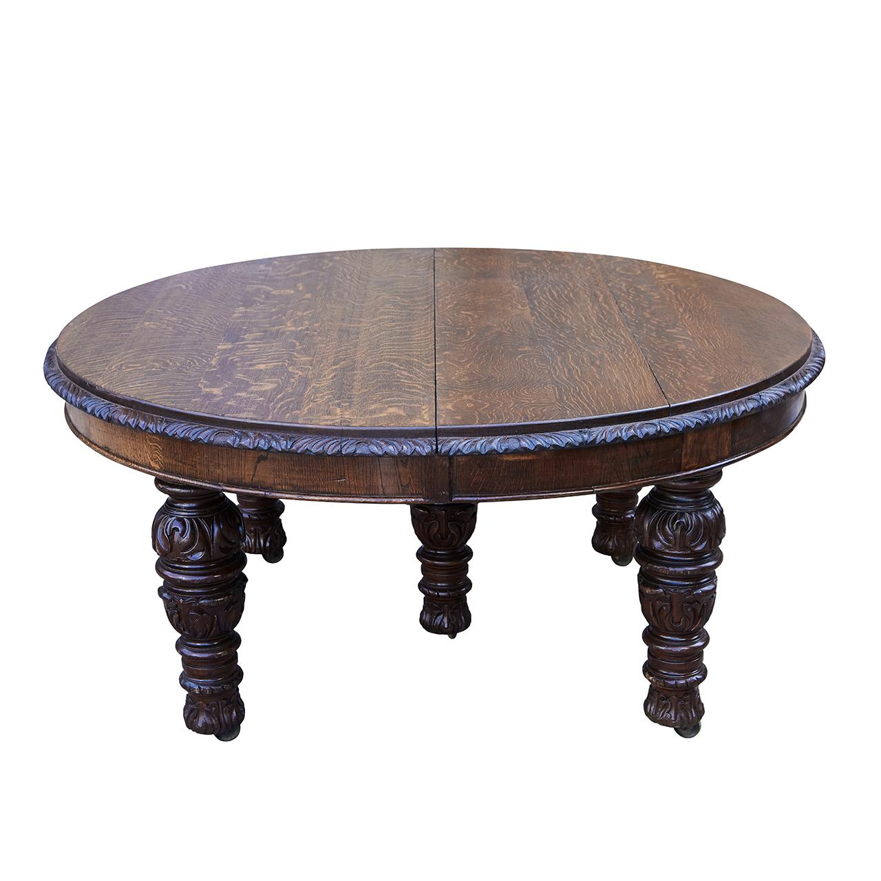 This beautifully carved oak table was made by a distinguished English manufacturer, James Phillips & Sons-Union St. Bristol, circa 1875. The piece has four center leaves that are fit into the table once it is opened by the hand crank. You have the
