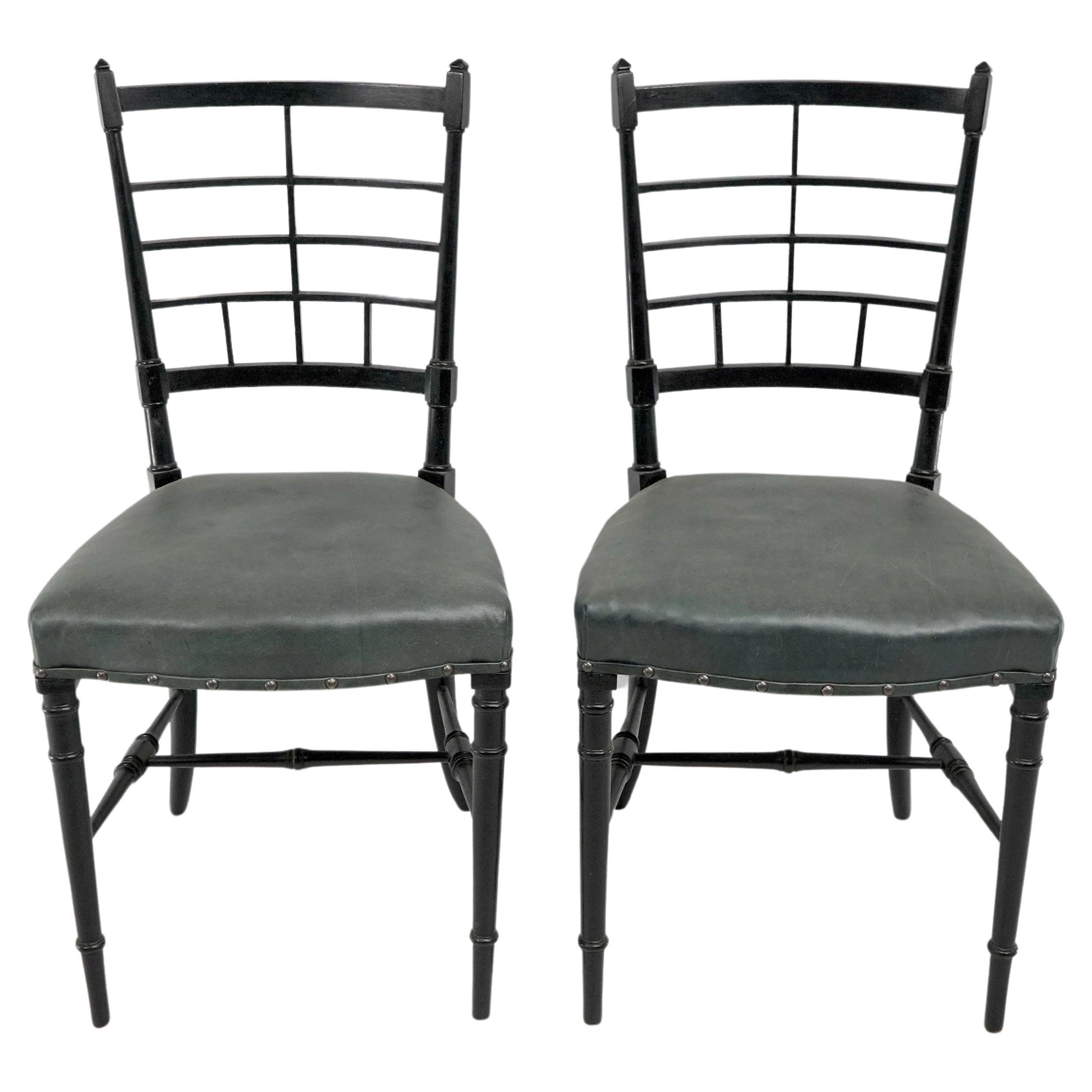 James Plucknett attributed probably for Collier and Plucknett. A pair of Anglo Japanese ebonized side chairs professionally upholstered in a quality hide
