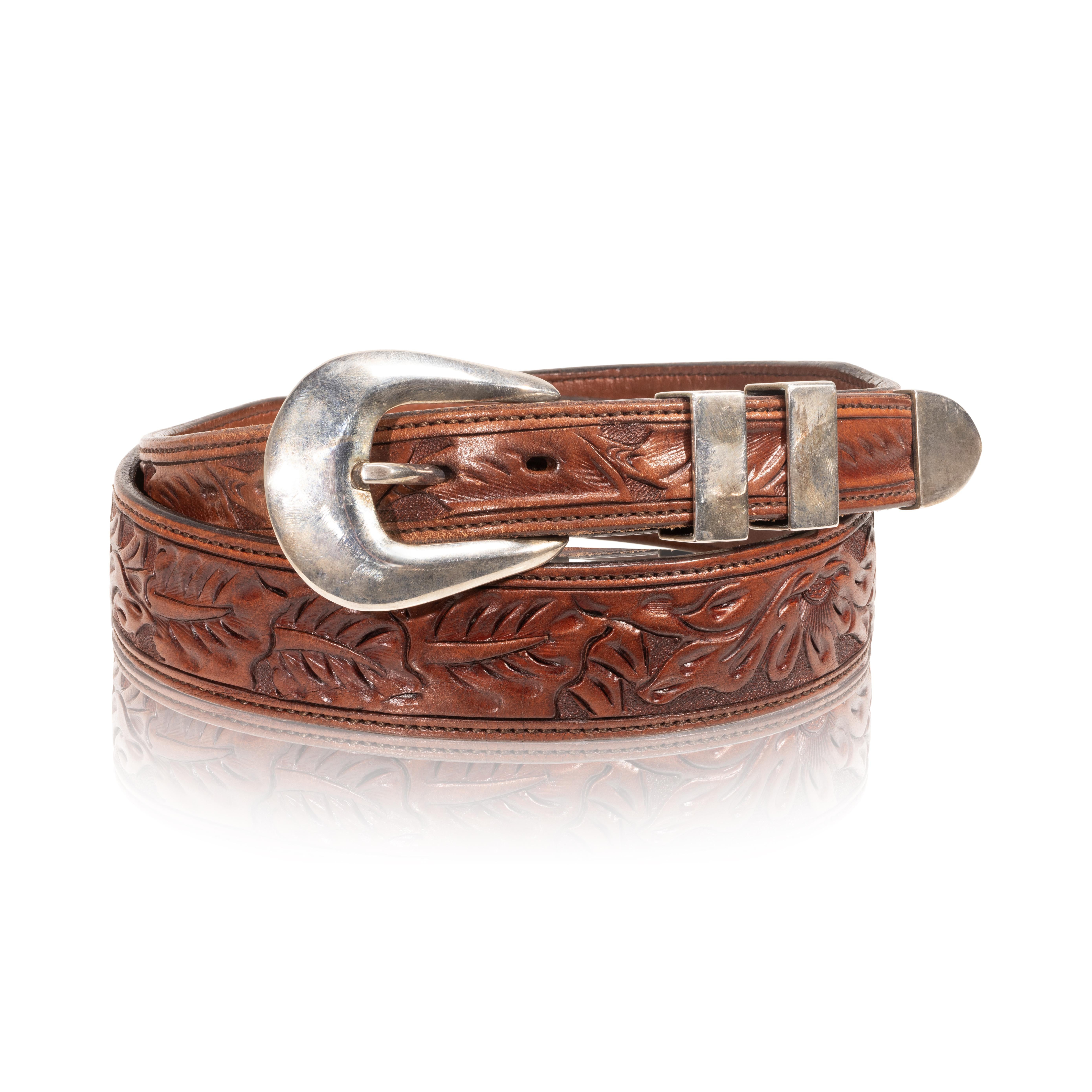 James Reid sterling buckle set on running oak tooled leather belt. Buckle loops and endpiece have no design other than highly polished surface. Stamped with James Reid signature hallmark on back. Buckle has very little patina, belt is in like new