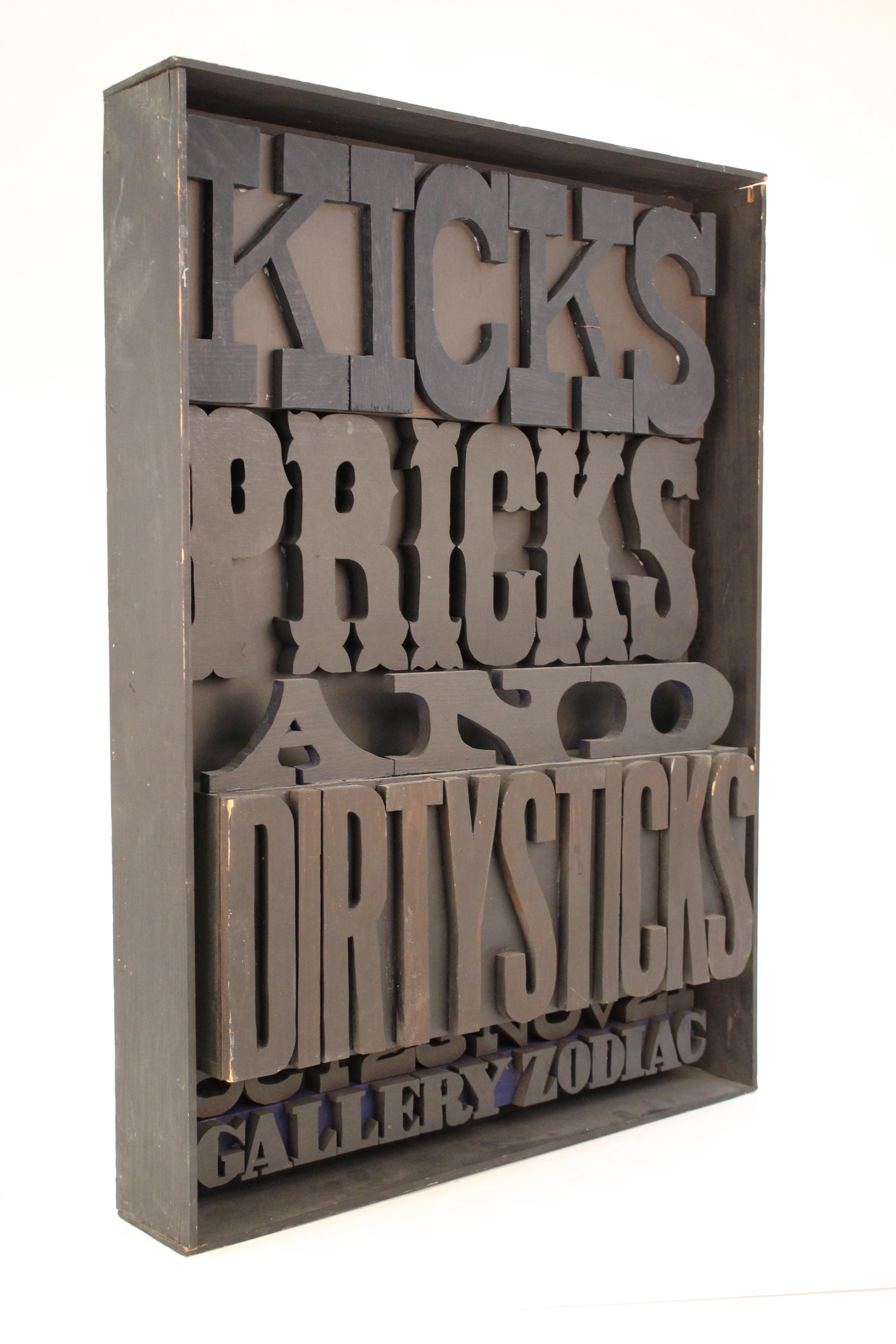 Gallery Zodiac wooden sign constructed in sculpted and cut out wooden lettering inside a box, made by James Russell. The piece spells out 'Kicks Pricks and Dirtysticks - Oct 23Nov 21 - Gallery Zodiac' and has a label on the backside. In good vintage