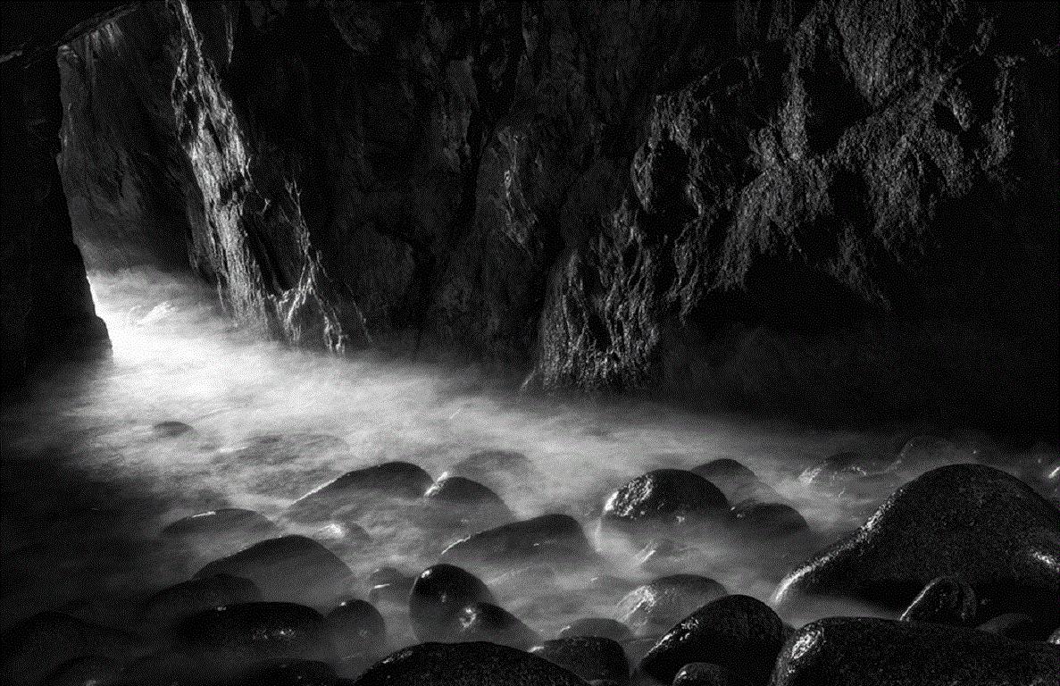 Aodh is a god of the underworld and prince of the Daoine Sidhe in Irish mythology.  The crashing waves in this cave  made its legend as a gateway to the realm of the Gods entirely  understandable…

James Sparshatt’s black and white landscapes have