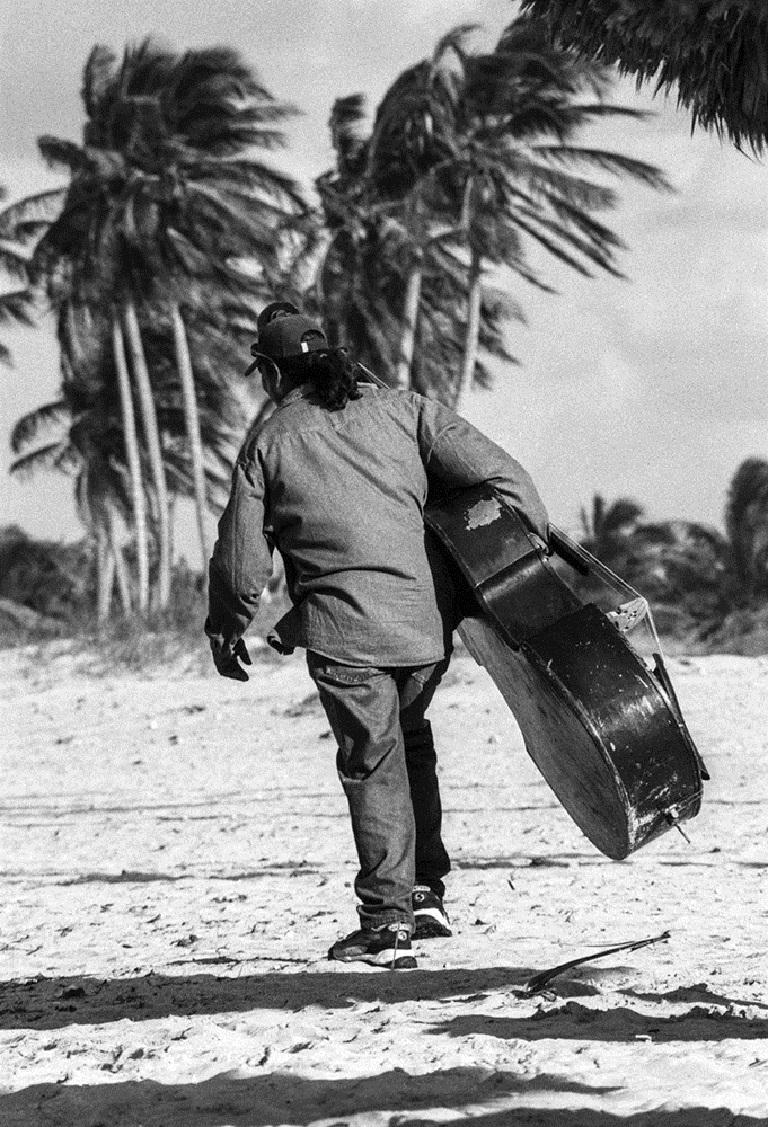 Double bass player wandering along Santa Elena beach in Cuba

James Sparshatt’s photographs of music and dance capture the emotion and intensity of people lost in the rhythm of the moment.

The work is available as silver gelatin and palladium