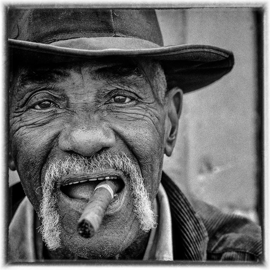 A man of gentlemany demeanour, content with his cigar.  A sentinel watching the world pass  amidst the endless sugar cane country of central Cuba.

The Spirit of the Revolution series documents the generation of Cubans that saw the dramatic changes