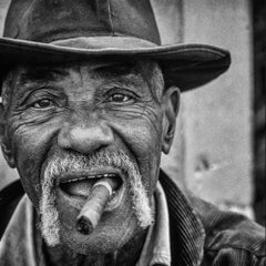 El Sentinel by James Sparshatt - Framed BW portrait of cigar smoking Cuban man