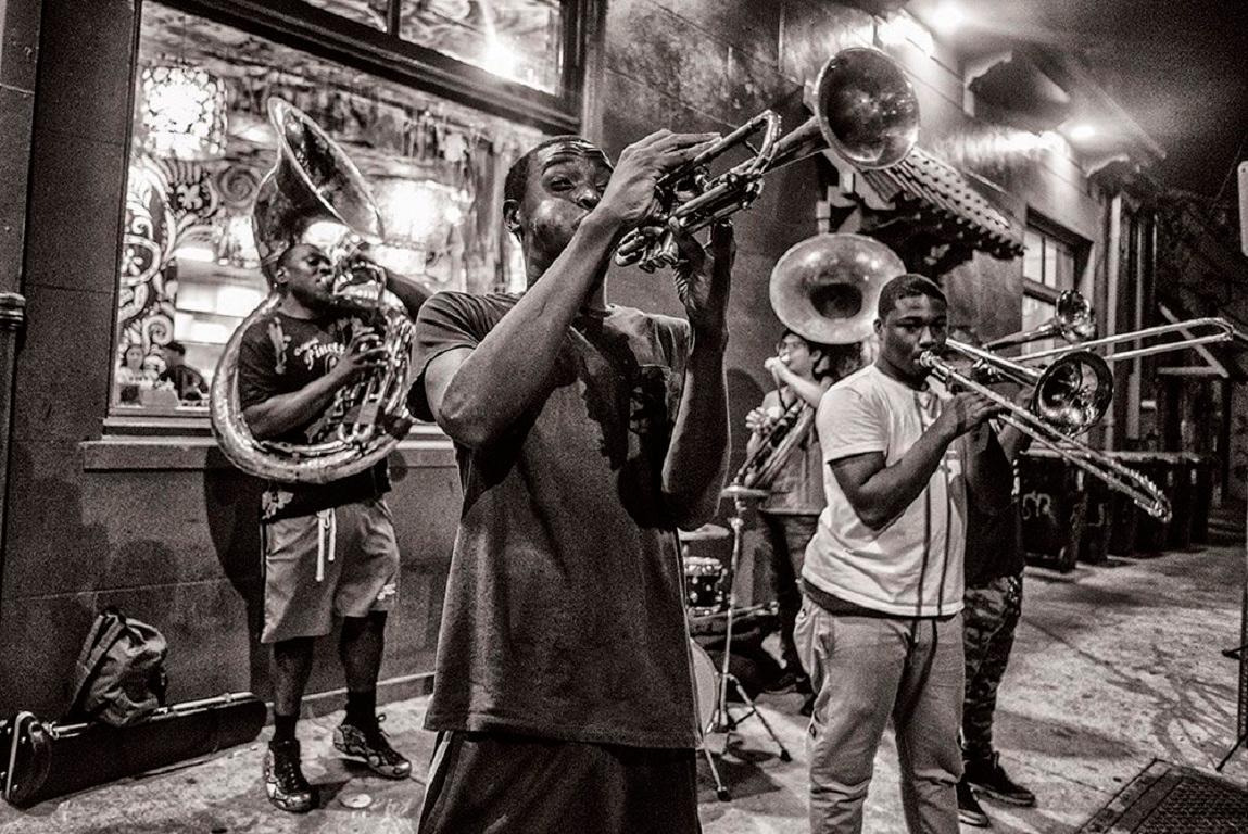 New Orleans is a mecca for music lovers from around the world. Wandering up Frenchmen Street on a sultry Louisianan evening is to be surrounded by competing sounds vying for attention. The Young Fellaz brass band station themselves on a street