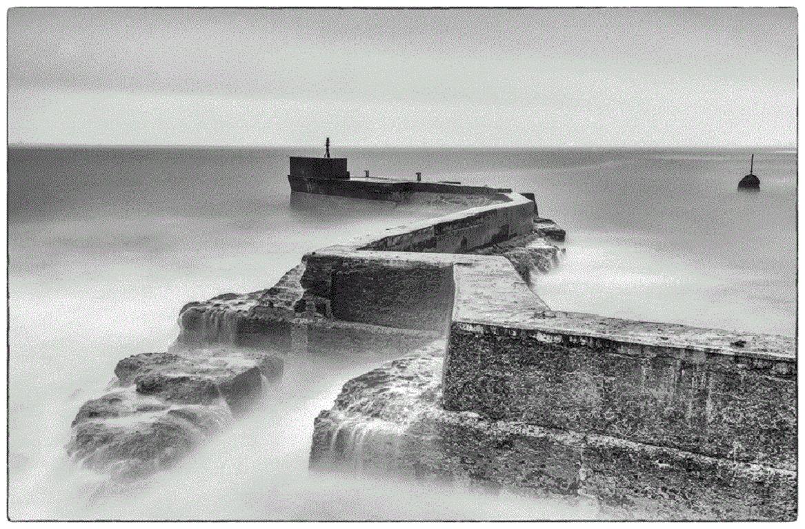 Rolling waves crashing against the breakwater in St Monan’s calmed by a long exposure after dark.

James Sparshatt’s black and white landscapes have an ethereal beauty.  They are moments when the natural form of topography is given magic by the