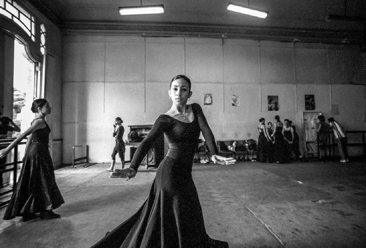 The school of Spanish dance is housed in the upper floors of the Teatro Garcia Lorca in Havana. The wooden floors of the rehearsal rooms are worn and pitted, the mirrors stained, but the dancers intensity is undimmed. Havana, Cuba, 2002.

James