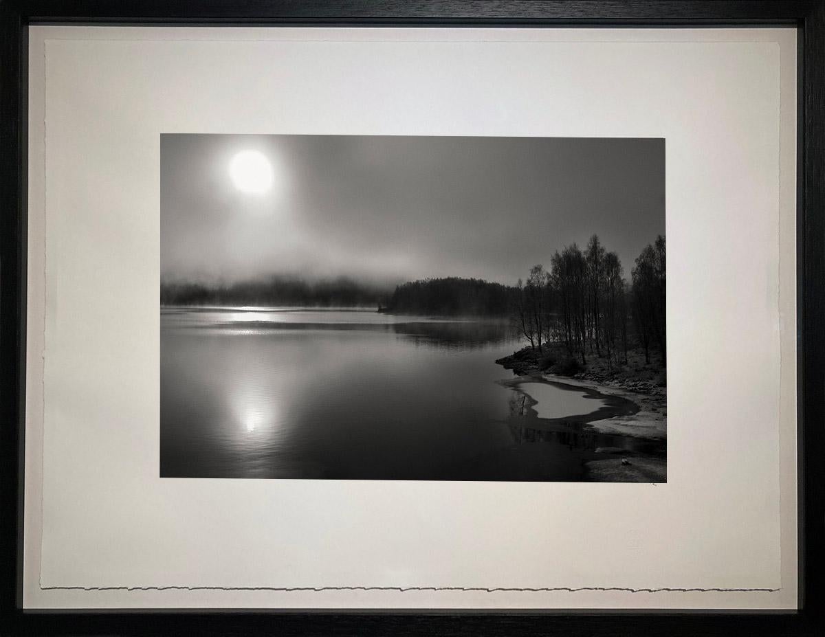 A frozen morning in the highlands of Scotland and the sun battles to emerge from the mists.

James Sparshatt’s black and white landscapes have an ethereal beauty.  They are moments when the natural form of topography is given magic by the transient