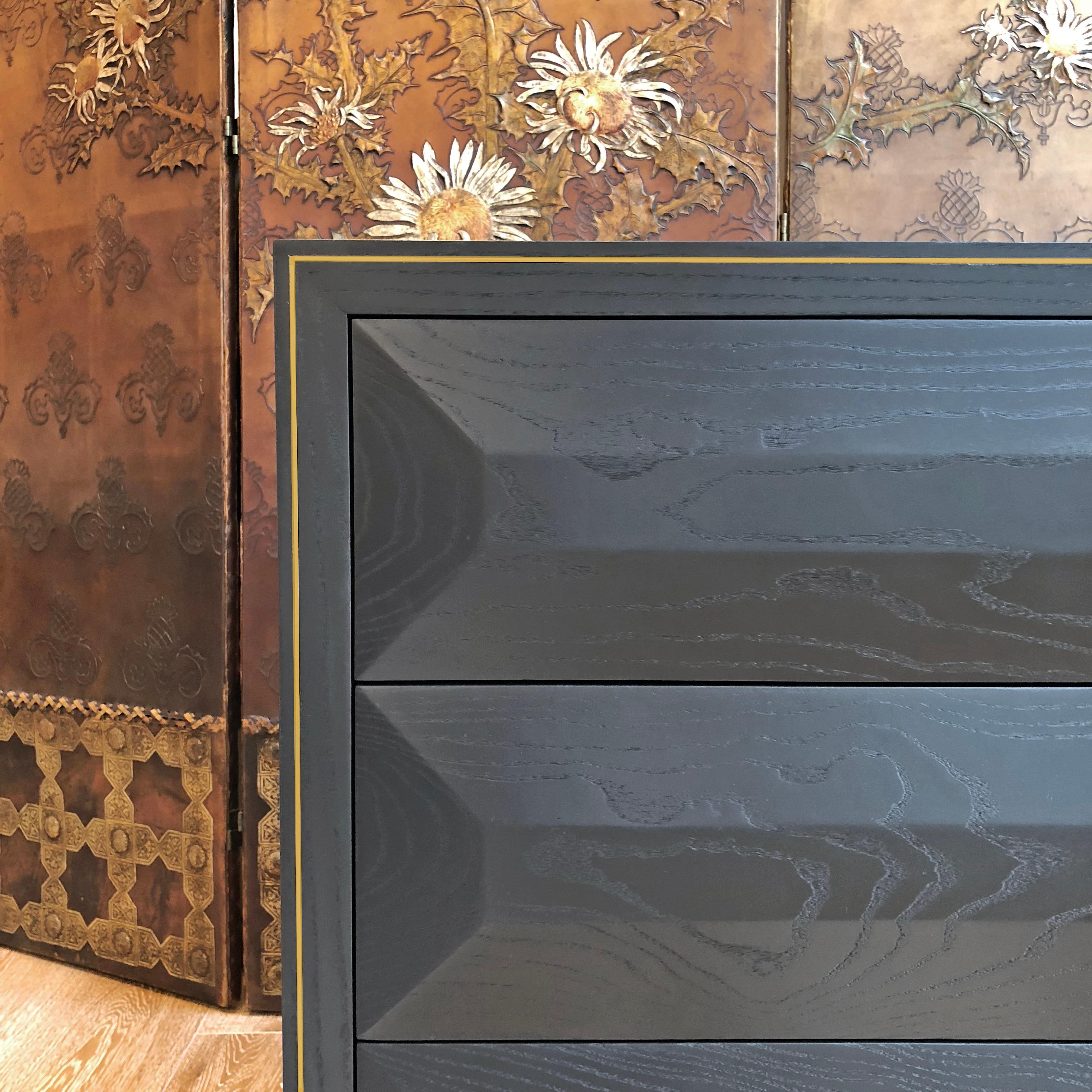 Black (RAL 9004) satin lacquered chest of drawers with brass plinth, push-to-open wood lined drawers and brass trim detailing.

Measures: 80 W x 45 D x 65 H cm.