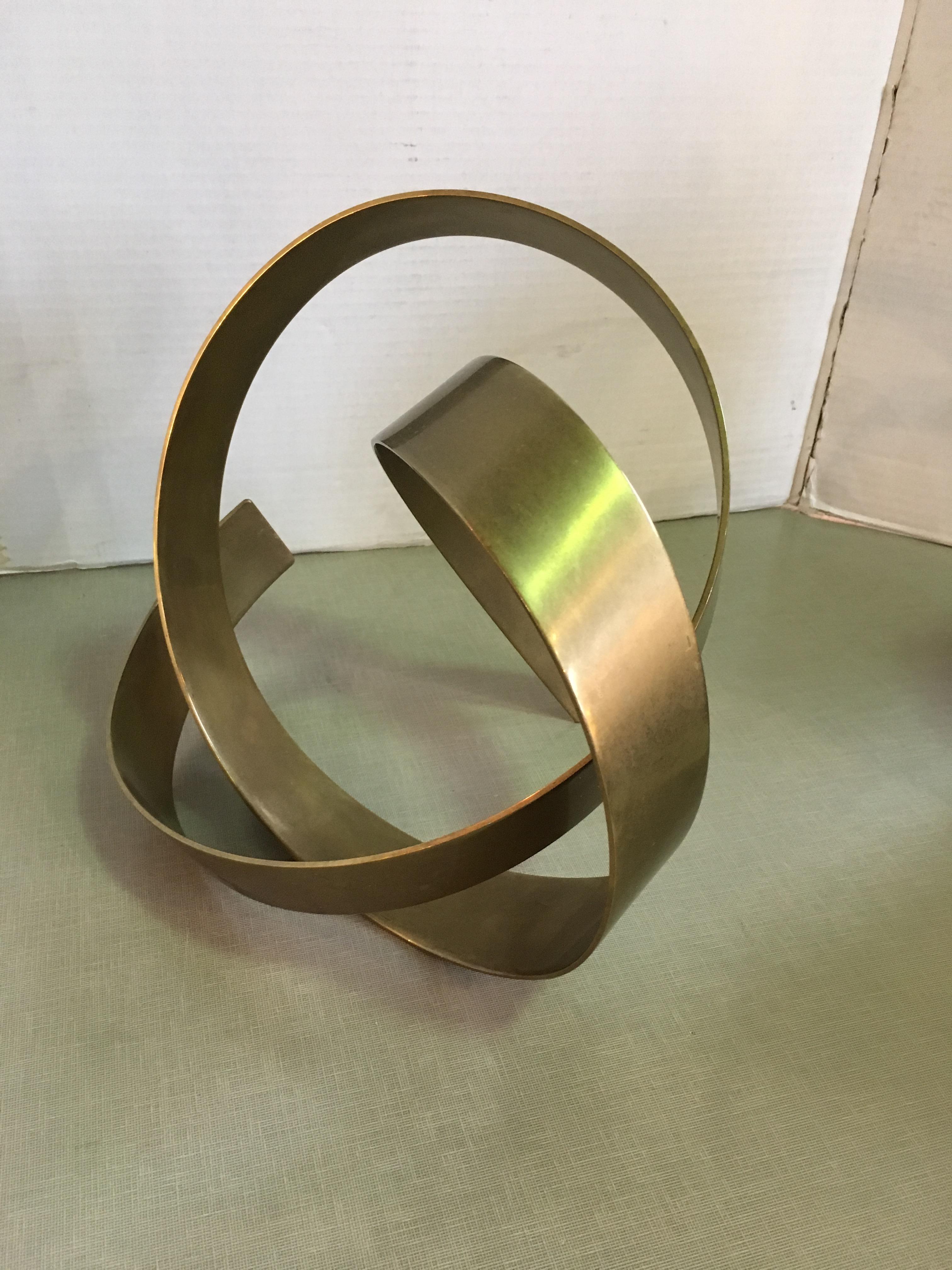This is a heavy brass abstract sculpture signed and dated by James W. Uhrig.