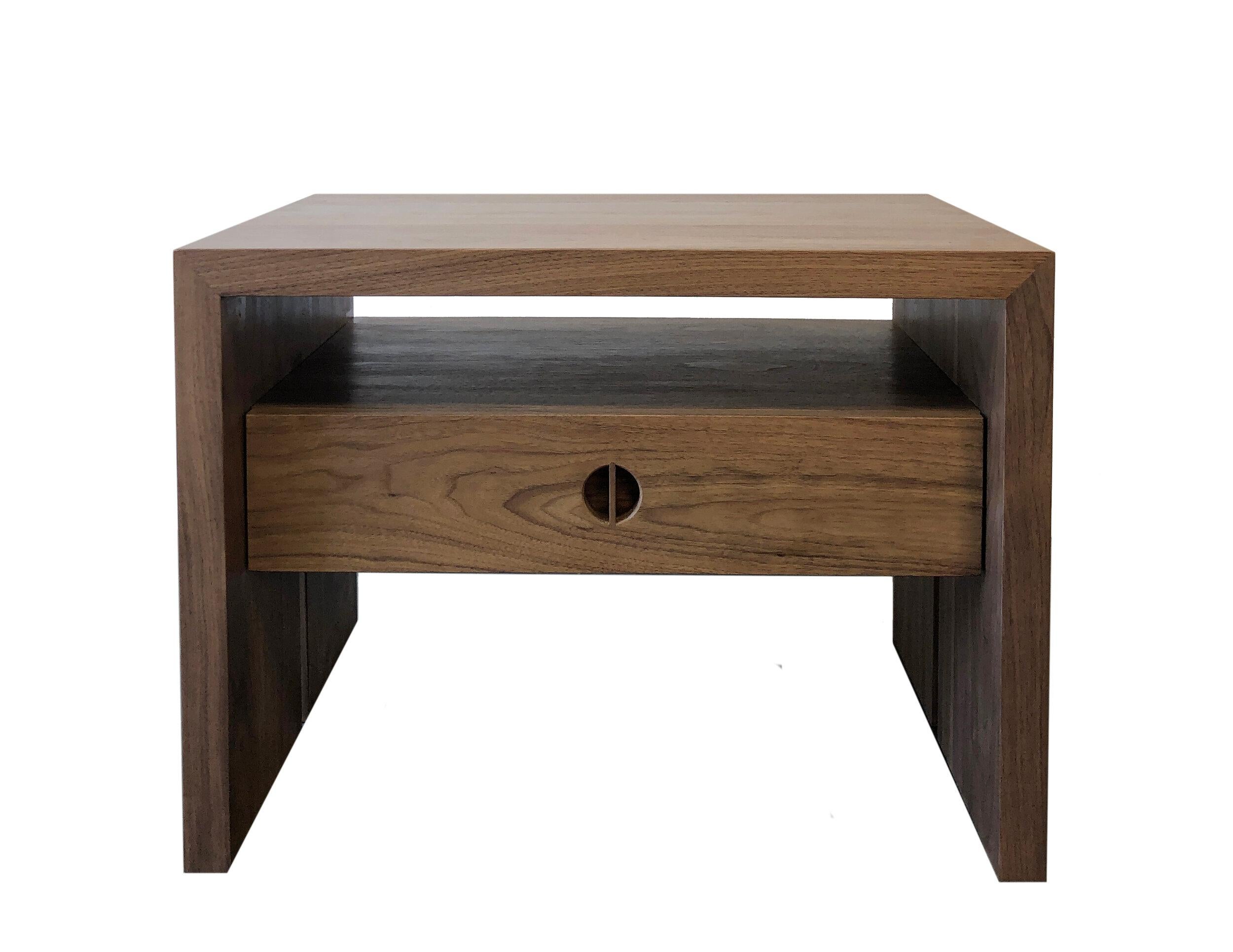 This custom nightstand with drawer is hand-made in the United States with all hardwood construction. Characterized by its striking waterfall design, unique split leg detail, and convenient and accessible storage drawer, the minimalist Jameson