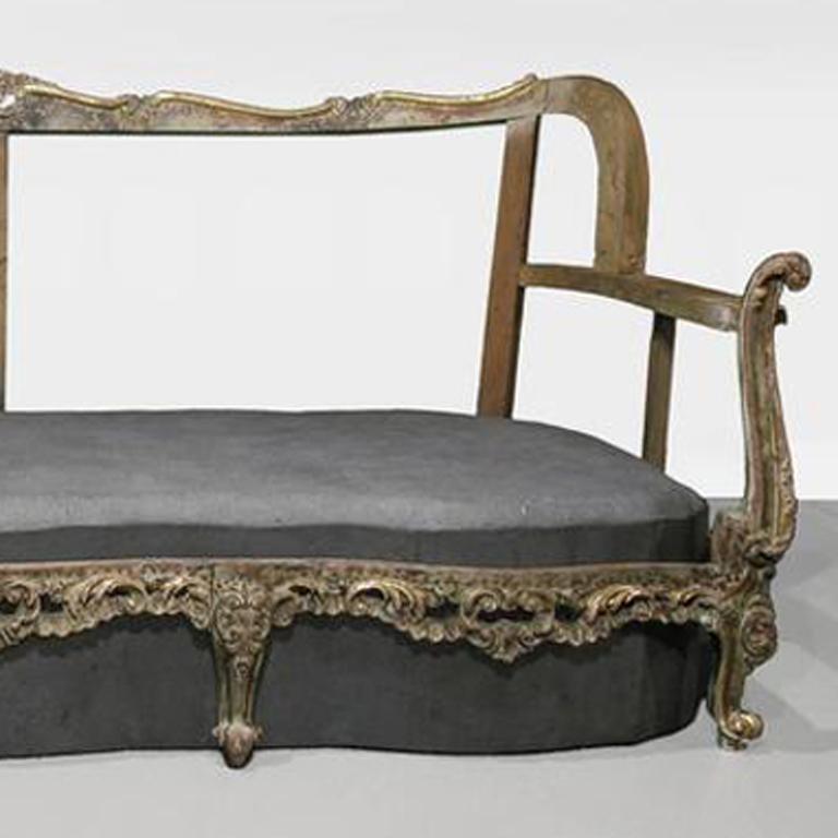 Sofa with antique frame and cast concrete seat.
