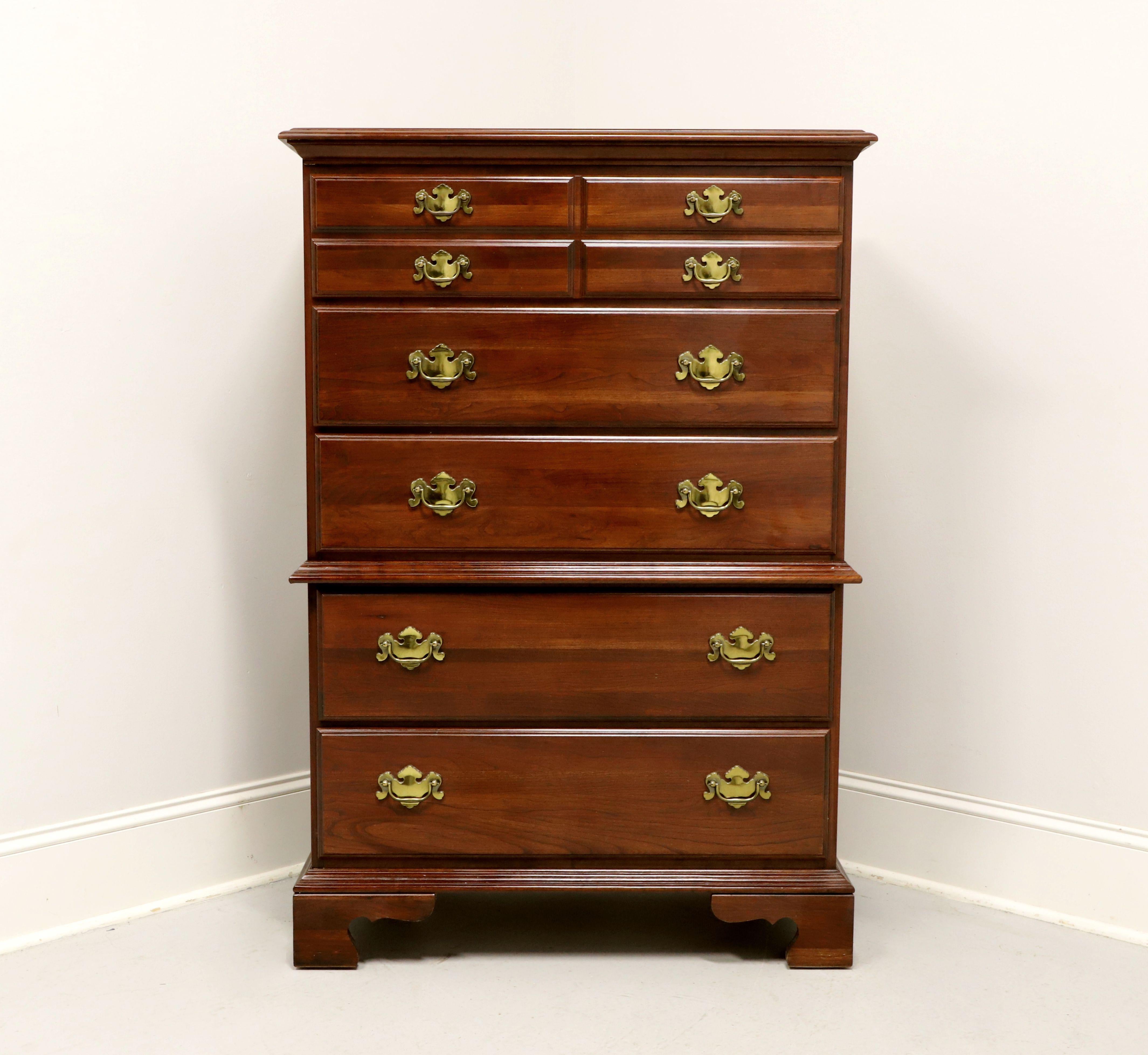 A Chippendale style chest on chest by Jamestown Sterling. Cherry with brass hardware, ogee edge to the top, ogee edge dividing chests, and bracket feet. Features five various size drawers of dovetail construction. Made in the USA, in the late 20th