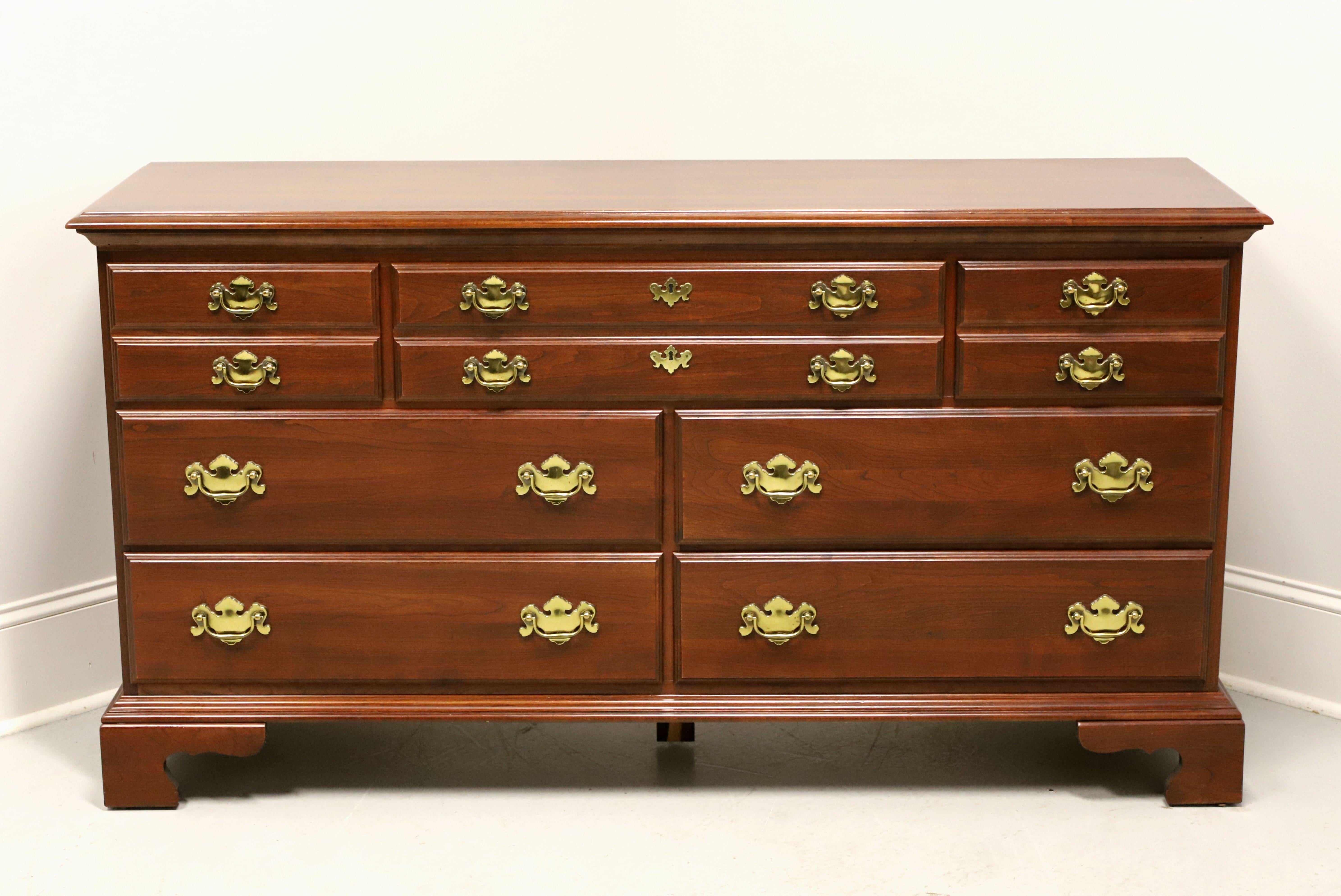 A Chippendale style triple dresser by Jamestown Sterling. Cherry with brass hardware, ogee edge to the top, and bracket feet. Features seven various Size drawers of dovetail construction. Made in the USA, in the late 20th century.

Style #: