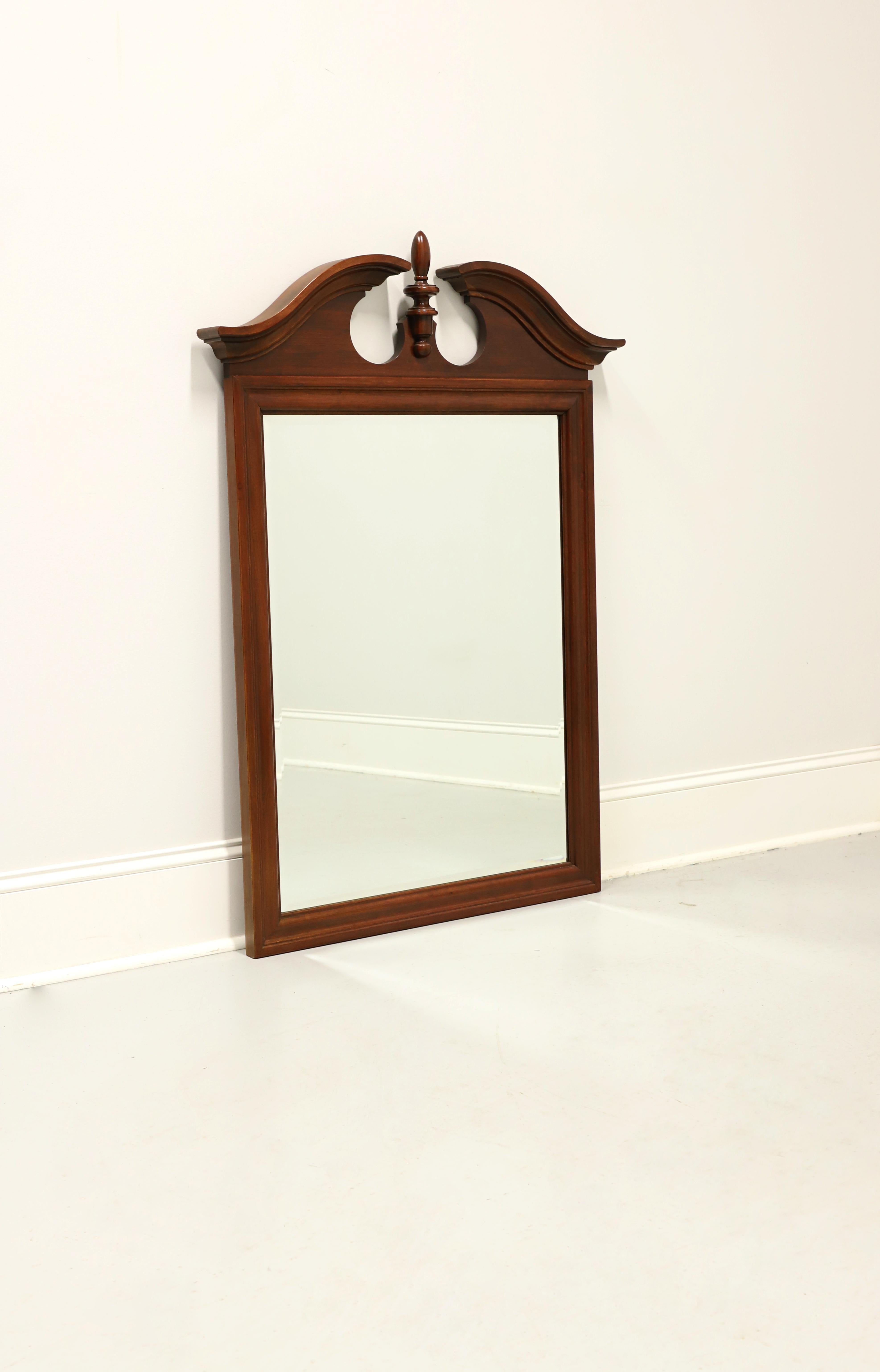A Chippendale style wall or dresser mirror by Jamestown Sterling. Beveled mirrored glass, distressed pecan frame with pediment and center finial to top. Made in Lenoir, North Carolina, USA, in the late 20th century.

Style #: D-7407

Measures: