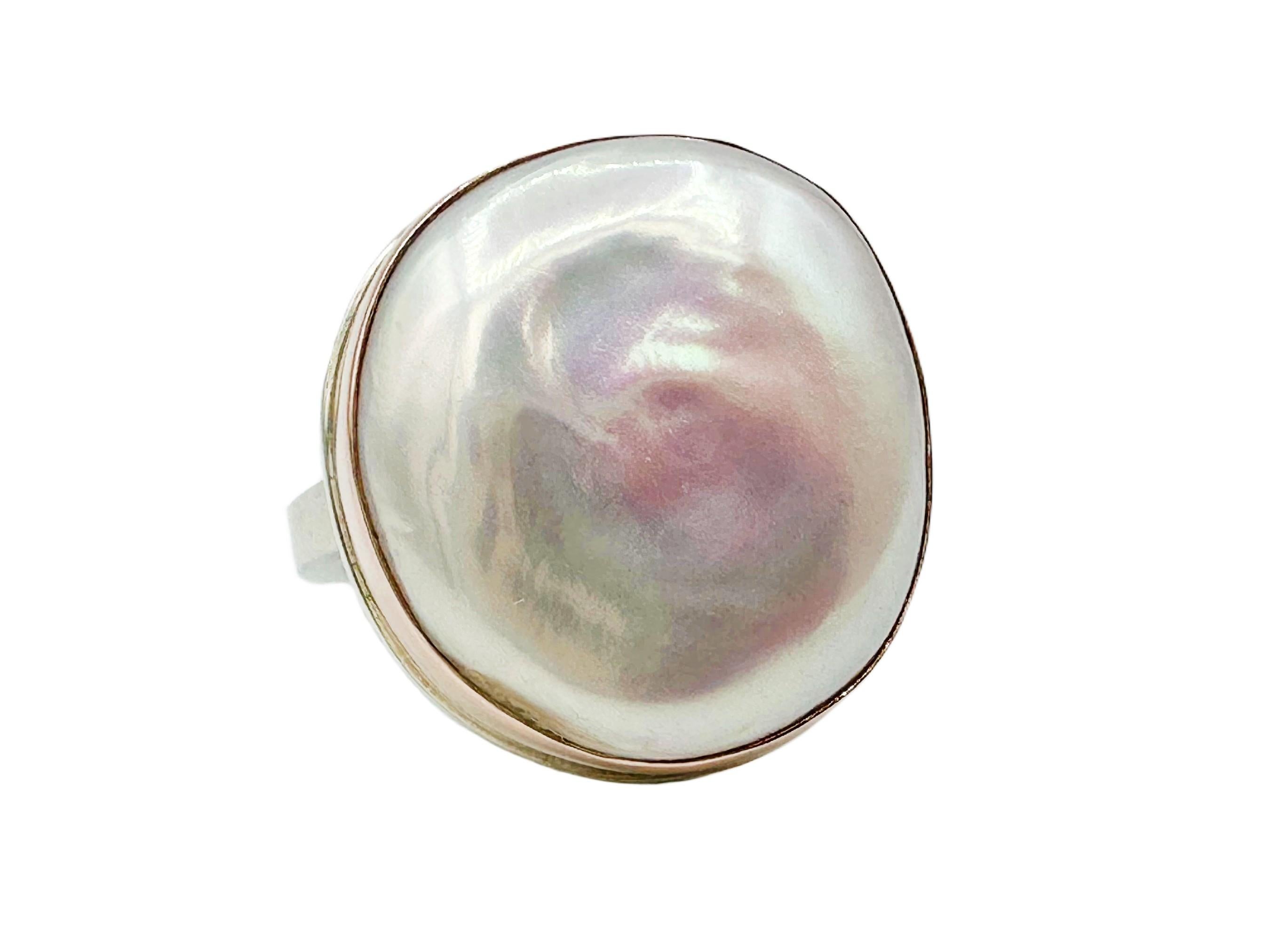 Gorgeous Jamie Joseph designer ring featuring a blush pink cultured pearl set into a 14k rose gold bezel atop a sterling silver platform and band. The pearl has a lustrous sheen and an organic shape reminiscent of dollops of cloud. The pearl has a