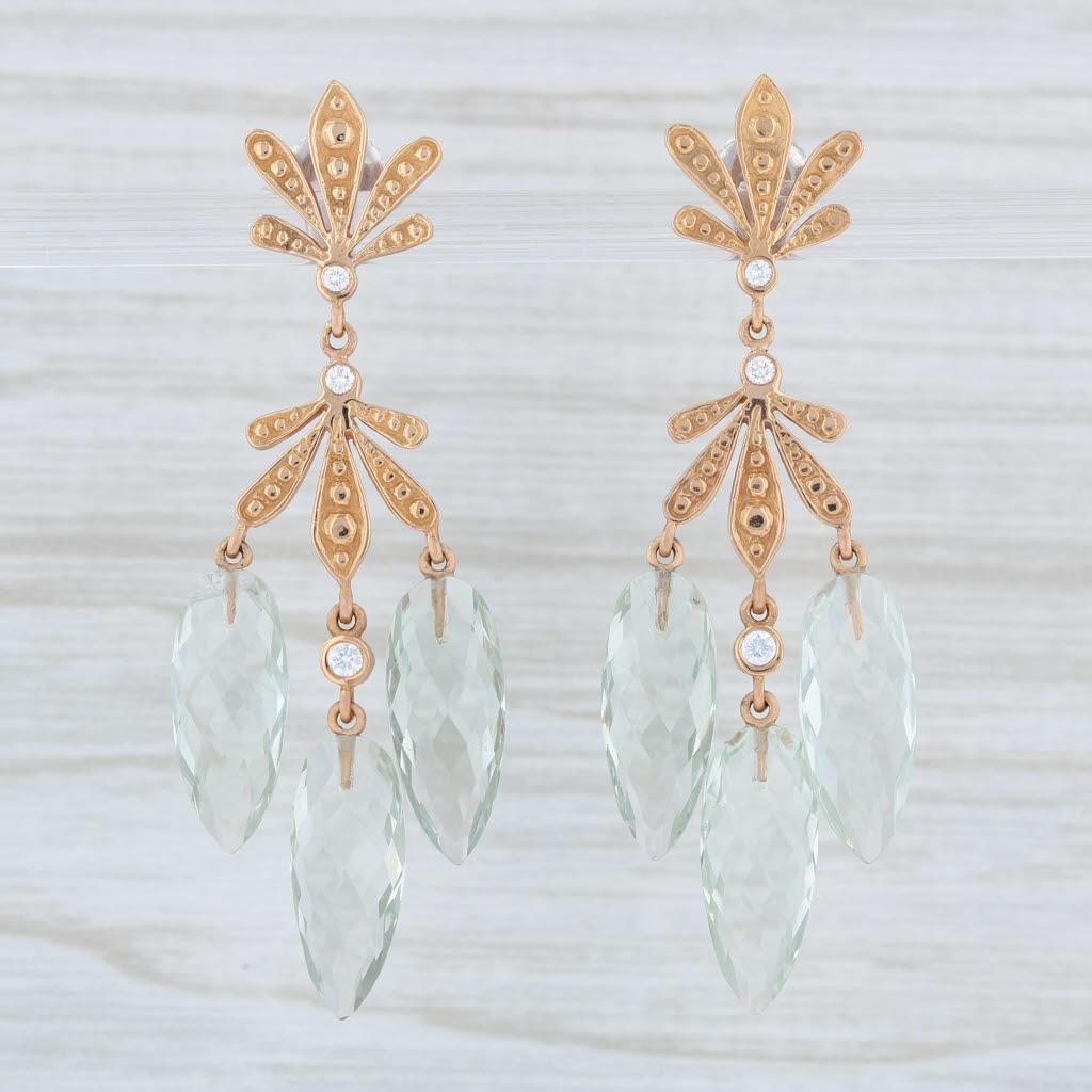 These lovely earrings are a Jamie Wolf design. Each earring has an ornate flourish accented by genuine diamonds and connecting green quartz briolette dangles. The briolettes have a beautiful faceting allowing light to add a brilliant shimmer.

Gem: