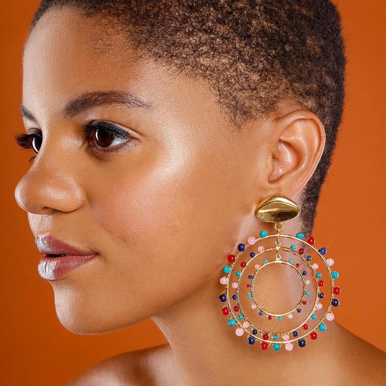 Maria Earrings are Brass with 14k Gold Plating.  Geometric Post with 3 Hoops wrapped with Multi-Colored Semi-Precious Round Stones 

Designed in New York by Jam + Rico:

