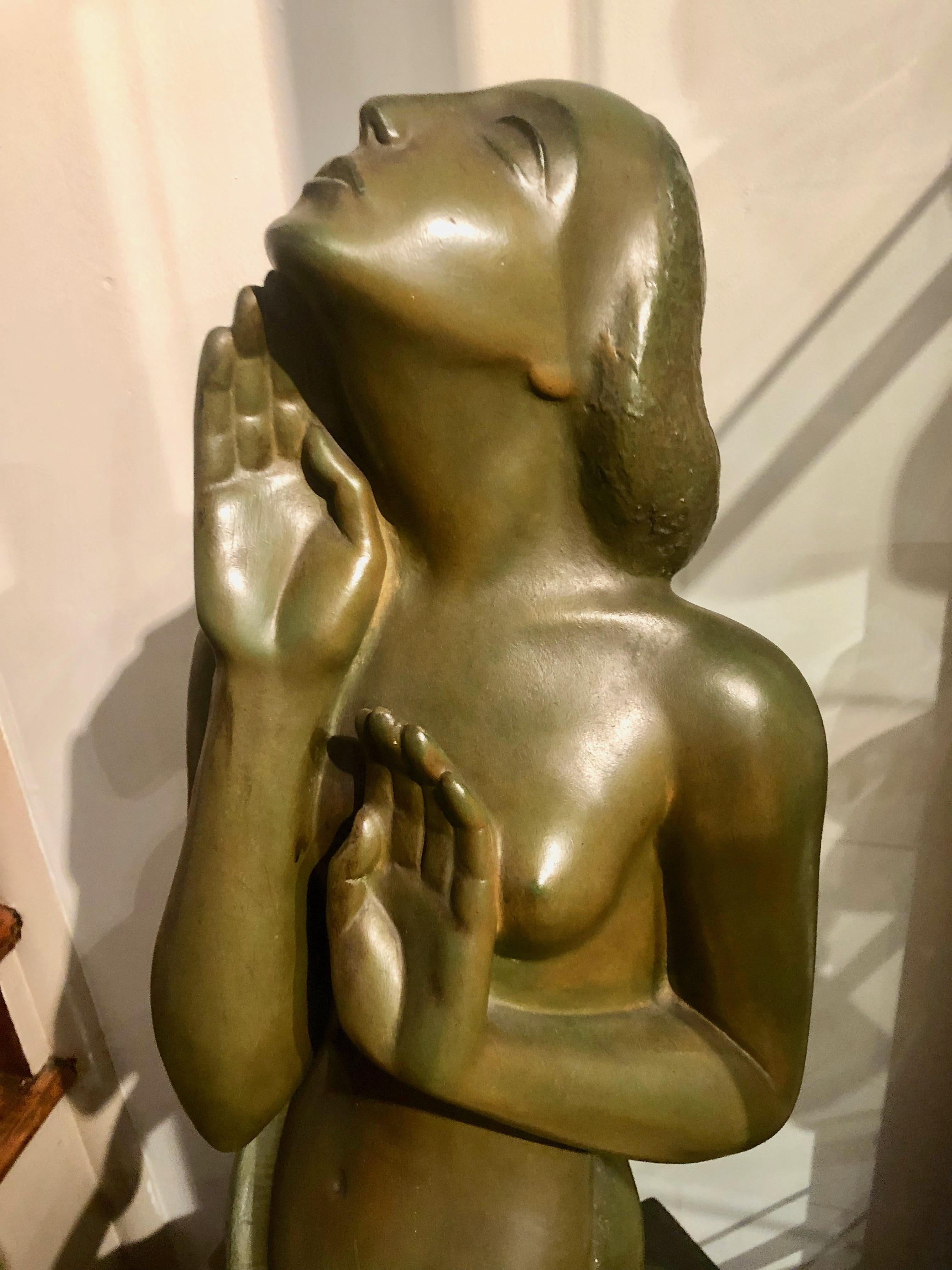 Art Deco female bronze sculpture by important Belgian artist, Jan Anteunis who worked primarily in the city of Ghent. A large and dramatic sculpture that features a very detailed and unusual stylized simply clothed woman who could be kneeling in a