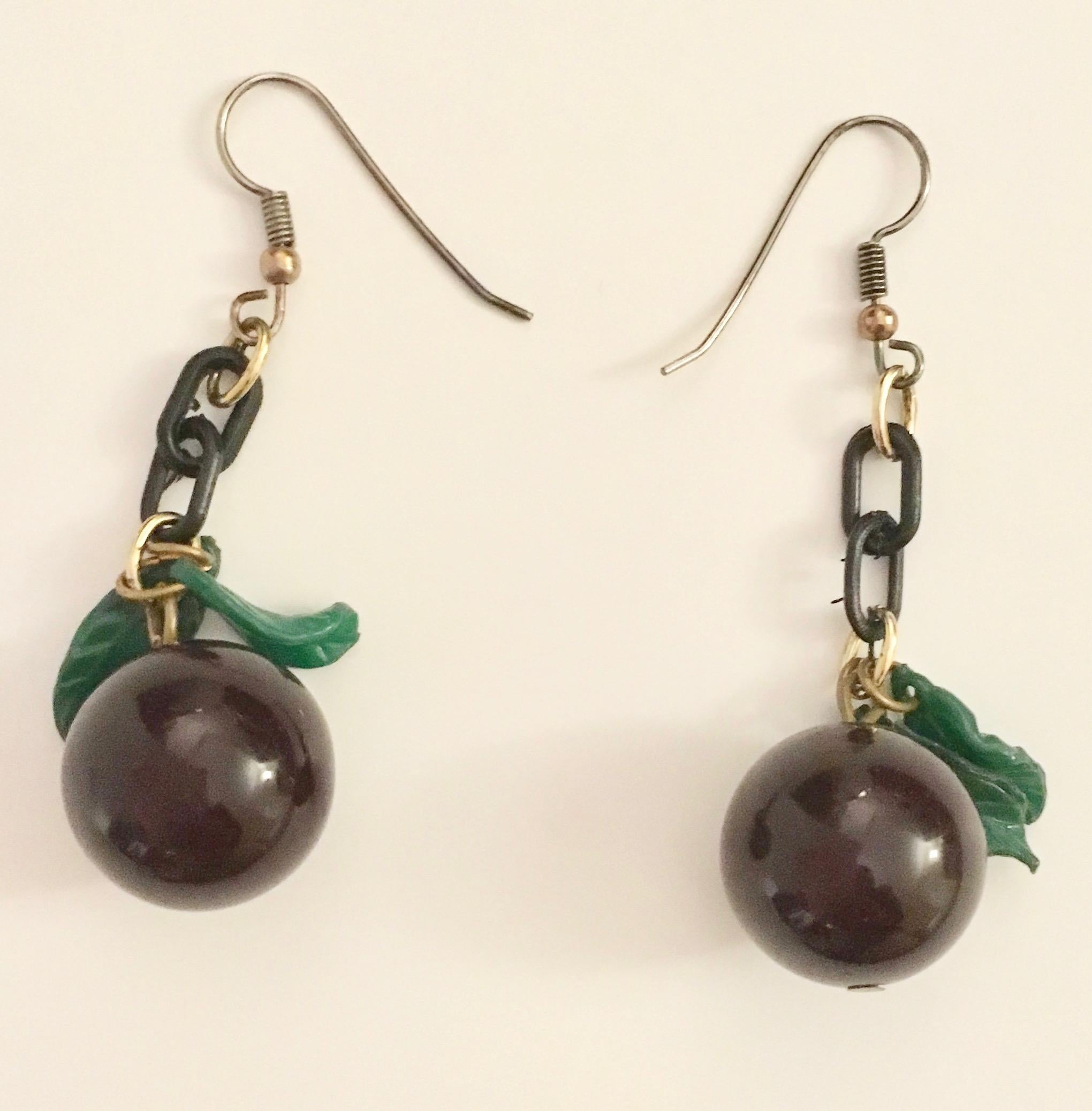 This beautiful pair of grape earrings are made from bakelite and from famed designer Jan Carlin. 