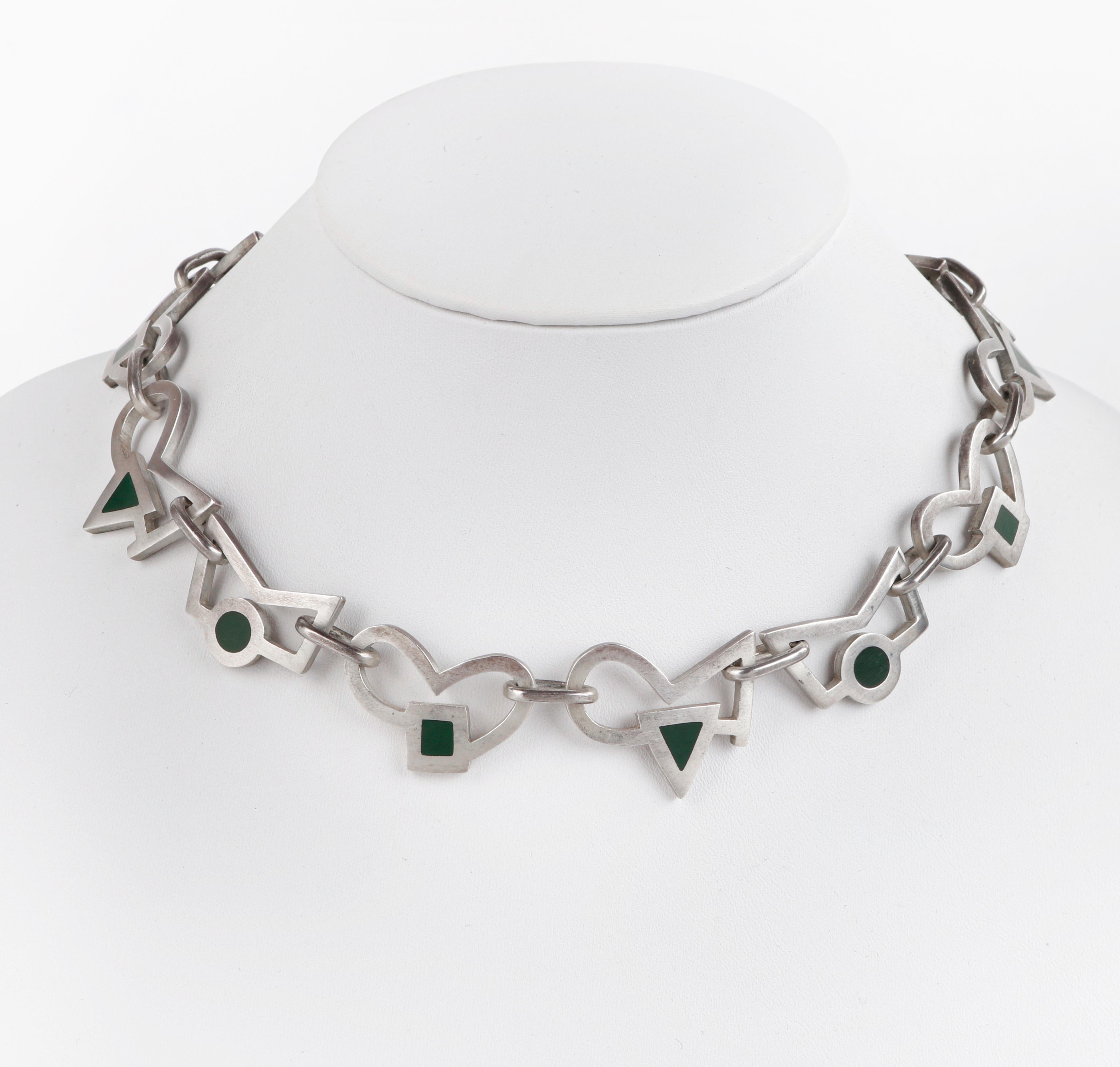 JAN GJALTEMA Stirling Silver Green Accented Abstract Shape Necklace Earring Set
 
Brand / Manufacturer: Jan Gjaltema
Style: Necklace; stud earrings
Color(s): Silver and green
Marked Material: “925” Sterling silver
Unmarked Material (feel of): Resin