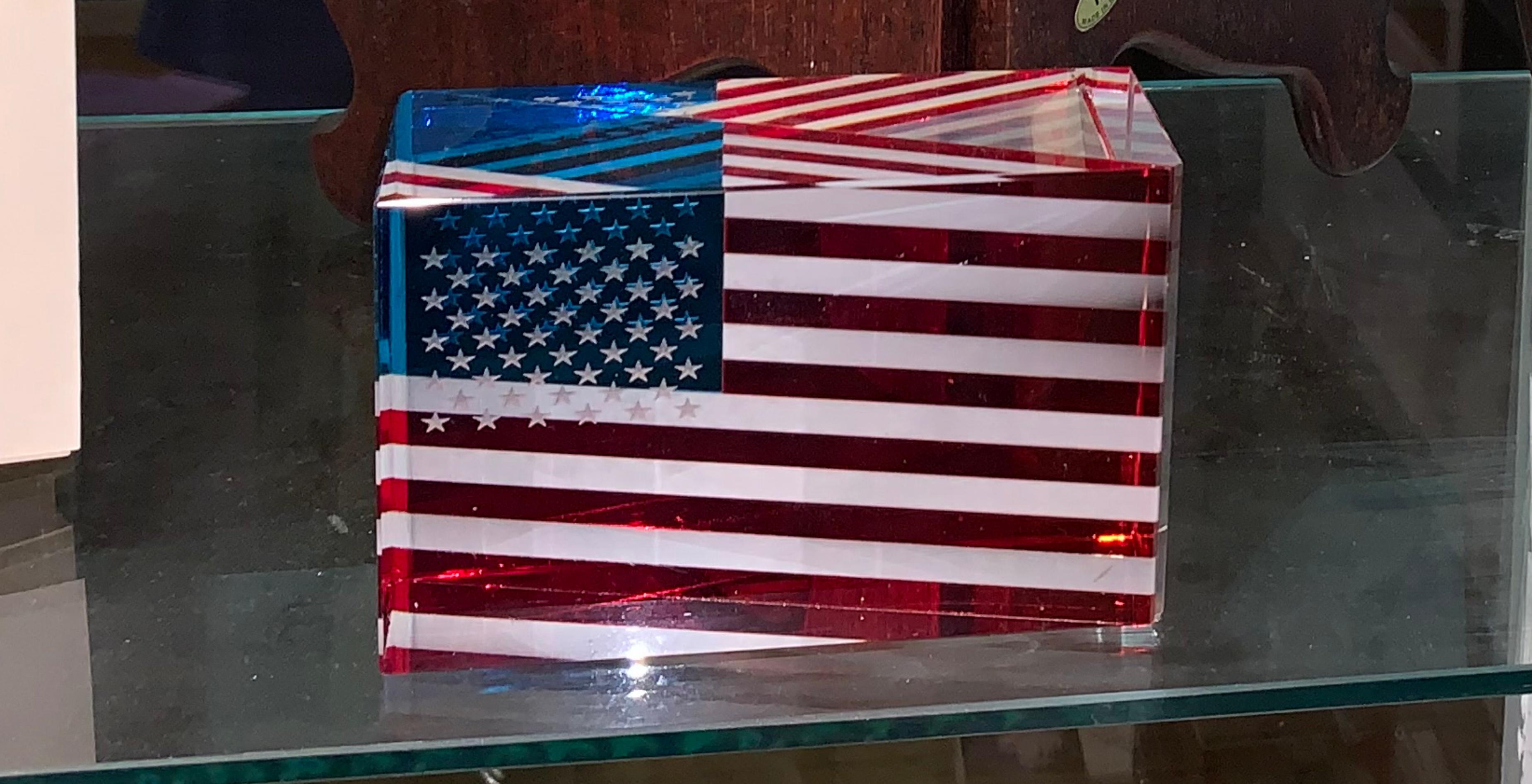 JAN MARES
Jan Mares (Czech, 1953-2005) 
Signed 3-D Glass American Flag, 2002
Cut, polished, and etched glass
3 × 5 × 2 inches
incised signature and date

Jan Mares was a celebrated Czech glass artist, known for his exquisite glass sculptures. 
