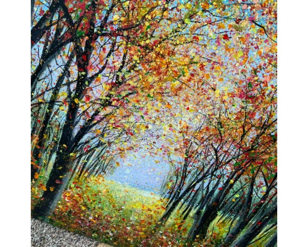 A seasonal acrylic painting, Autumn colours, golds, rusts and greens contrast with the lilacs and blues of the sky. Sunlight breaks through lightning up the woodland floor, highlighting a delicate confetti like carpet of leaves. Inviting and curious
