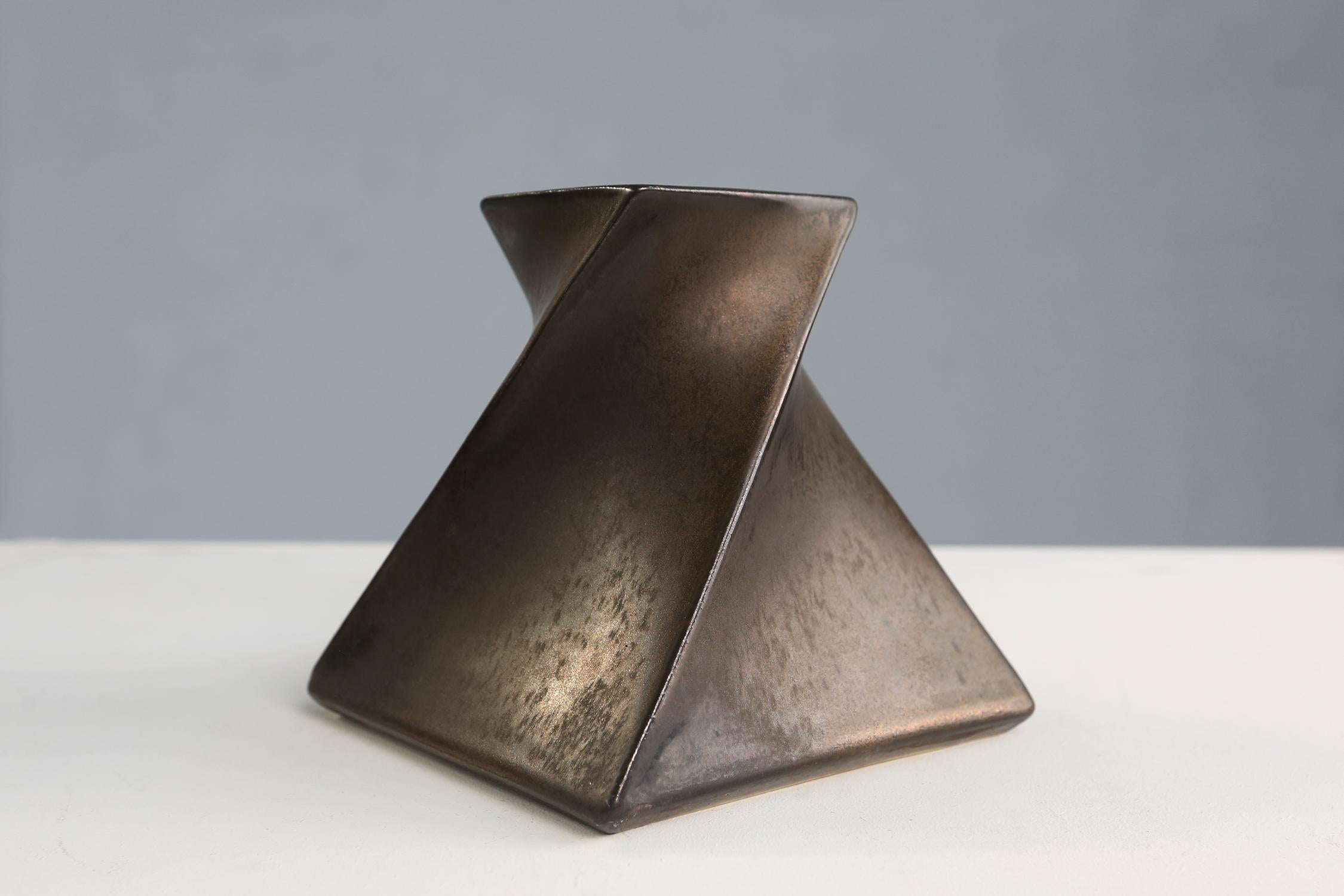 Bronze glazed ceramic geometric candle holder designed and made in the atelier of Jan van der Vaart, Holland 1978. This vase has a very nice bronze color glaze and nice geometric shape. This vase is made for tea lights.

The vase is signed at the