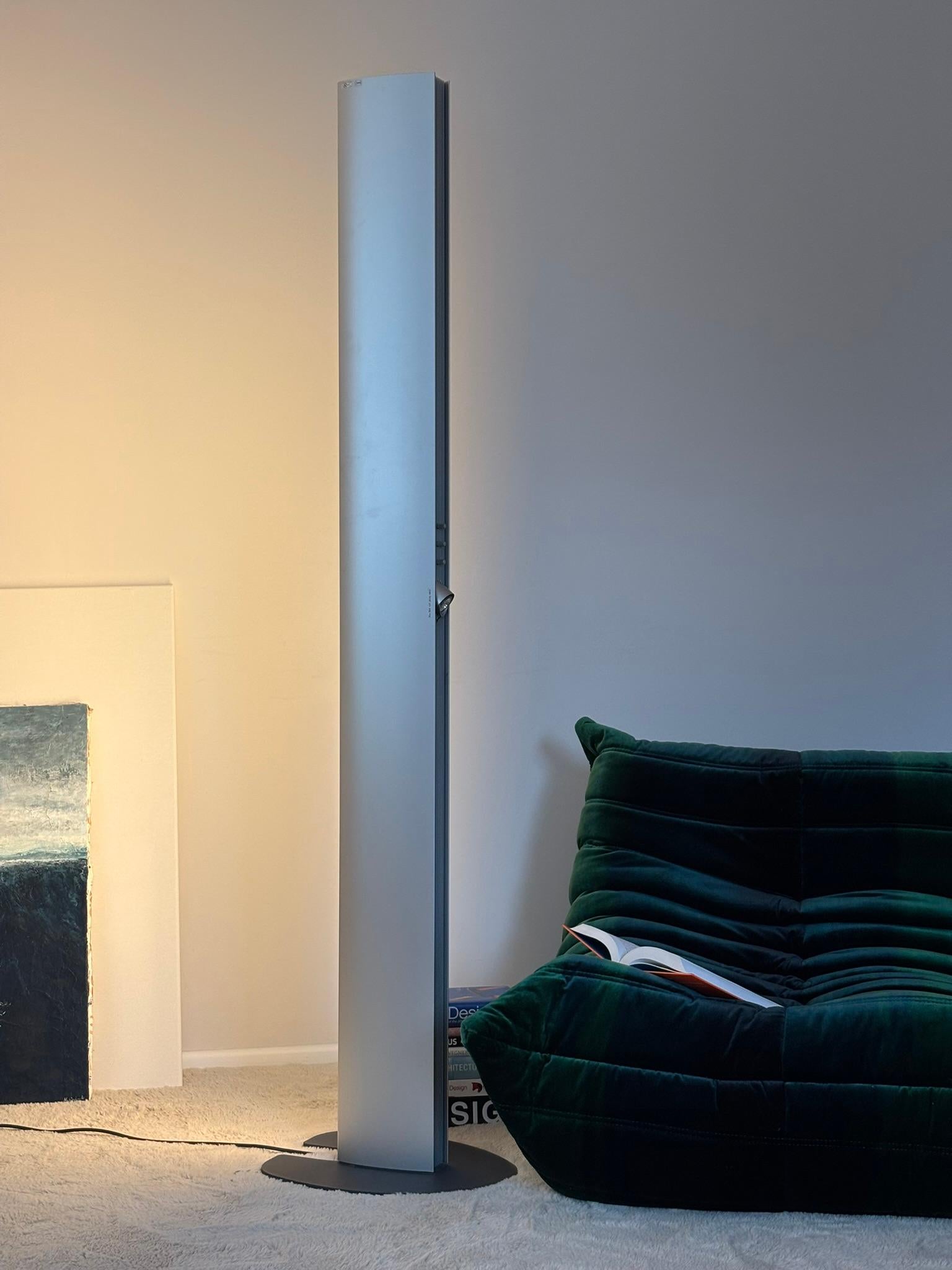 Echos floor lamp designed in the 1980s by Jean Van Lierde and produced by Artemide. The sculptural tower lamp features three separate light sources; halogen at the top, a dimmable swivel spotlight in the middle and a long fluorescent tube on the