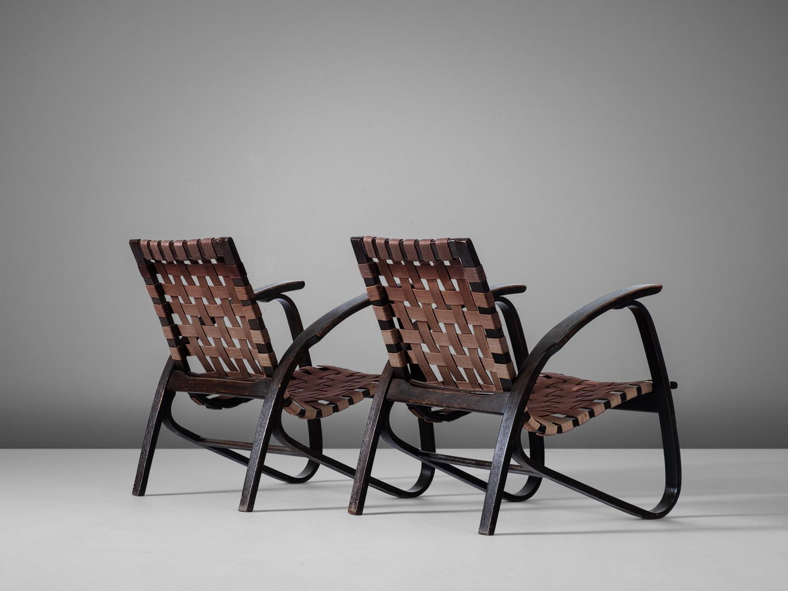 Pair of lounge chairs, in wood and canvas, by Jan Vanek for UP Zavodny, Czech Republic, 1930s.

Stunning pair of dynamic armchairs designed by Czech architect Jan Vanek, who was a contemporary of Jindrich Halabala. These chairs are upholstered