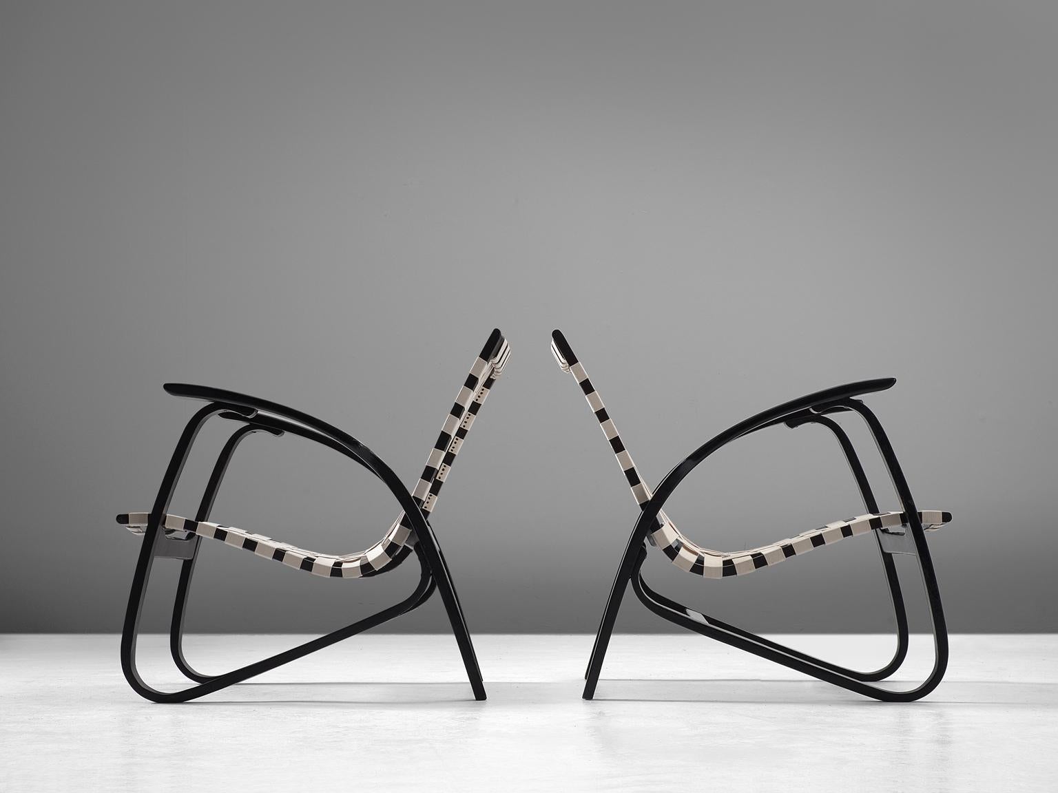 Jan Vanek for UP Zavody, pair of lounge chairs, in wood and canvas, Czech Republic, 1930s. 

Stunning pair of dynamic armchairs designed by Czech architect Jan Vanek, who was working in the same period and style as Jindrich Halabala. These chairs