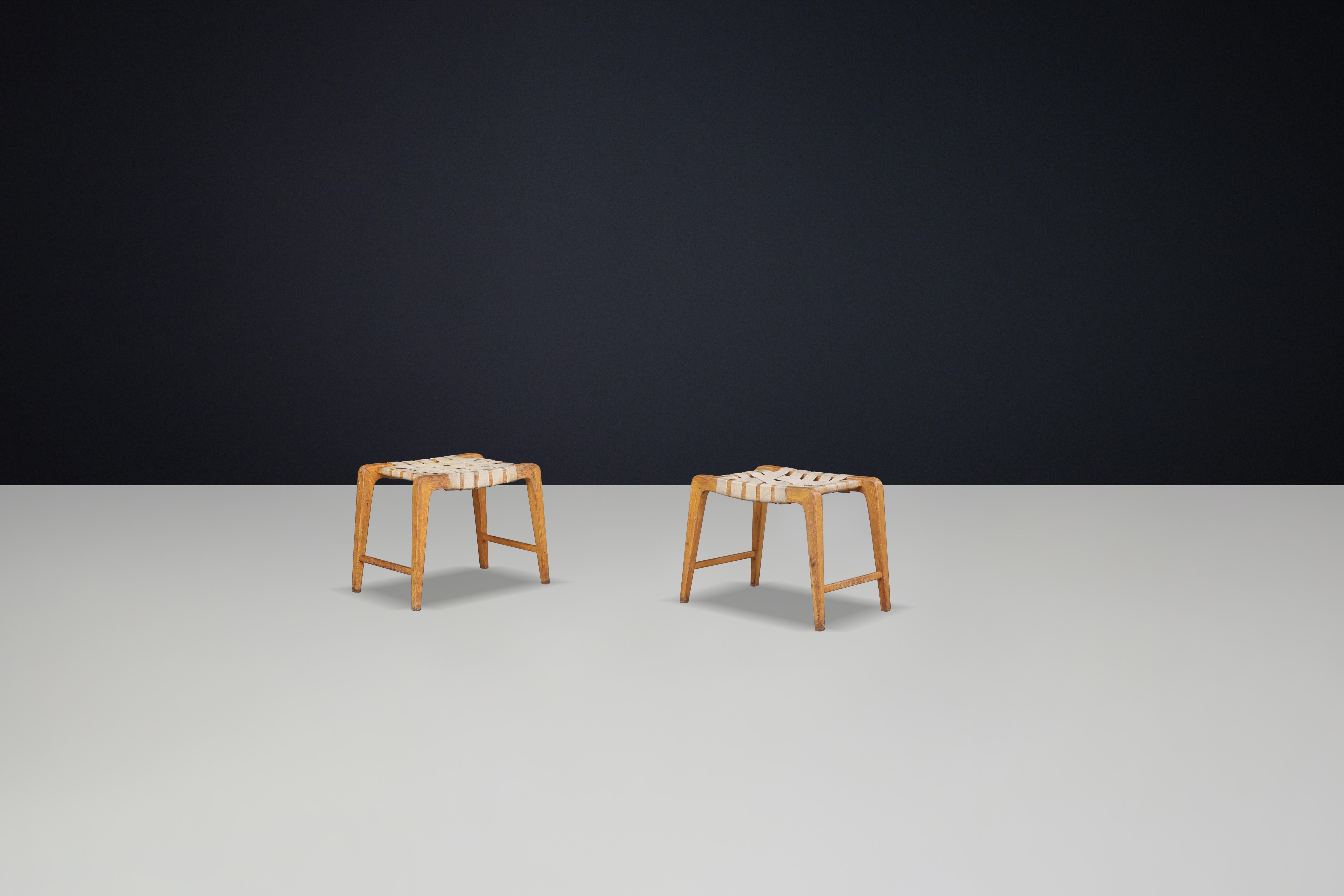 Jan Vanek sculptural set of two oak stools, crafted featuring woven canvas straps,  Prague 1940s 


Jan Vanek's sculptural set of two oak stools, crafted from oak and featuring woven canvas straps, dates back to the 1940s in Prague. Designed during