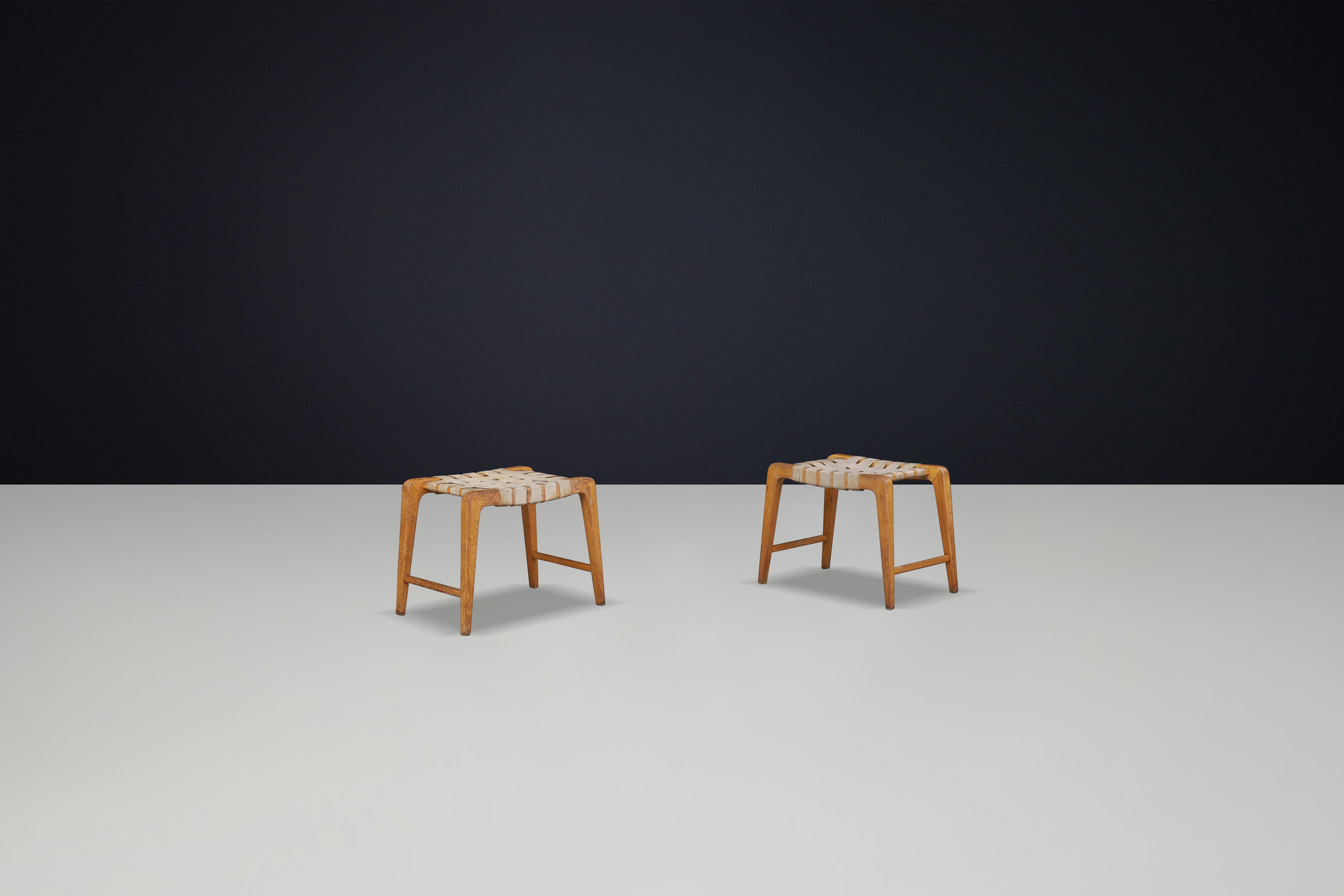 Czech Jan Vanek sculptural set of two oak stools featuring woven canvas straps, 1940s For Sale