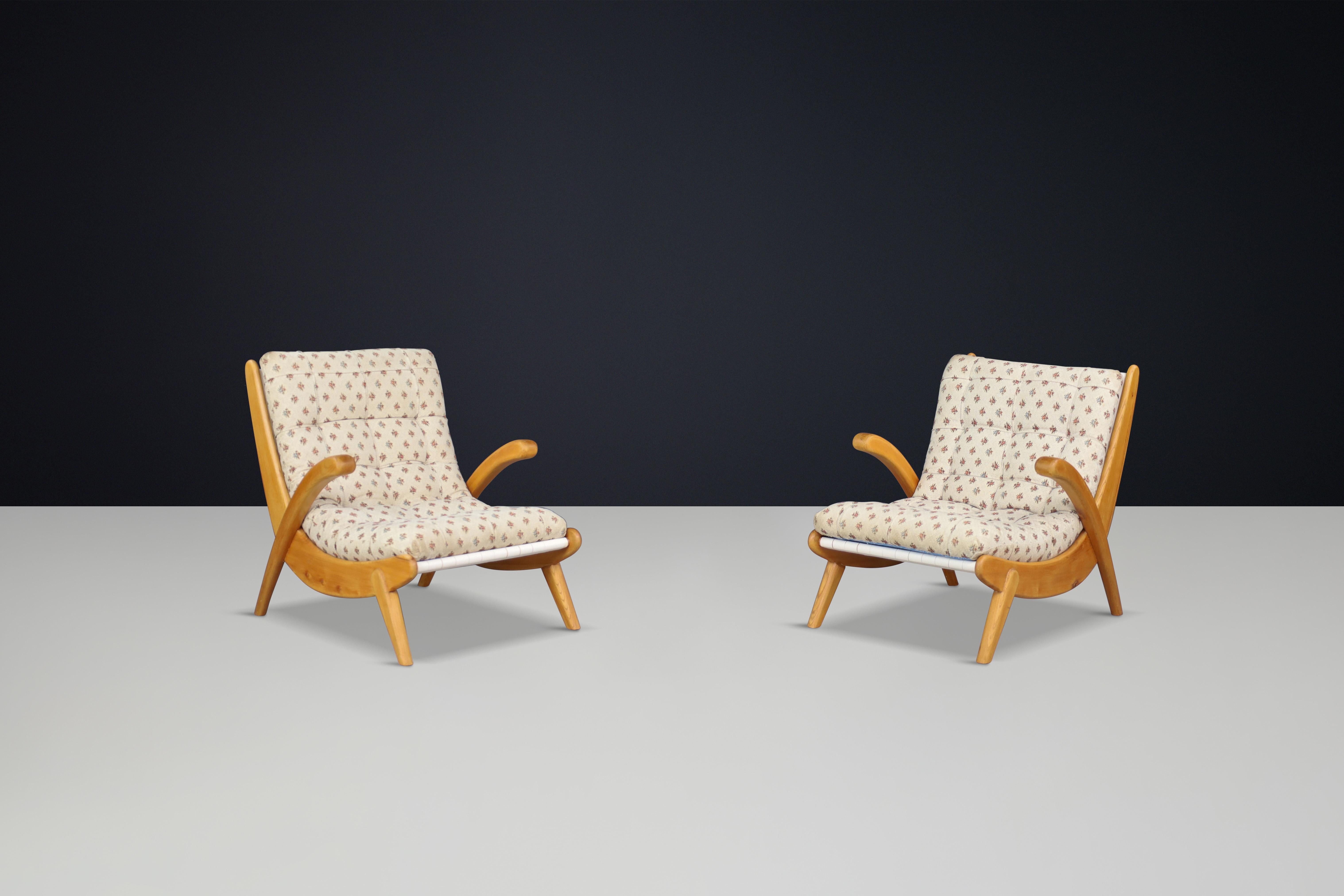 Jan Vanek's pair of two curved easy chairs curved oak, canvas and original upholstery, CZ 1960s

Jan Vanek's pair of two curved easy chairs, crafted from oak and featuring woven canvas straps with original floral upholstery, dates back to the 1940s