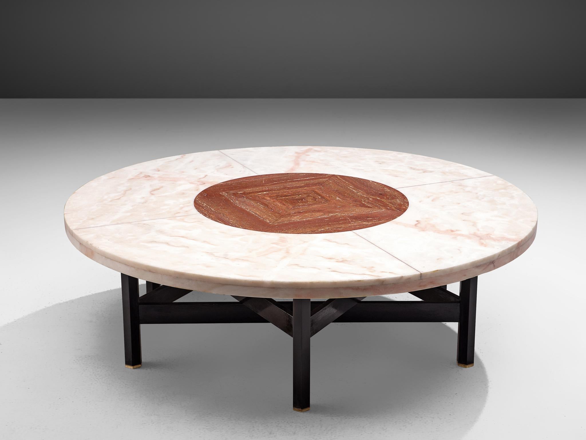 Jan Vlug, cocktail table, wood, marble, travertine and brass, Belgium, 1970s.

Exclusive coffee table with characteristic graphical base and round stone top. The base, made of dark lacquered wood, consists of six legs, formed into a star-shape. Two