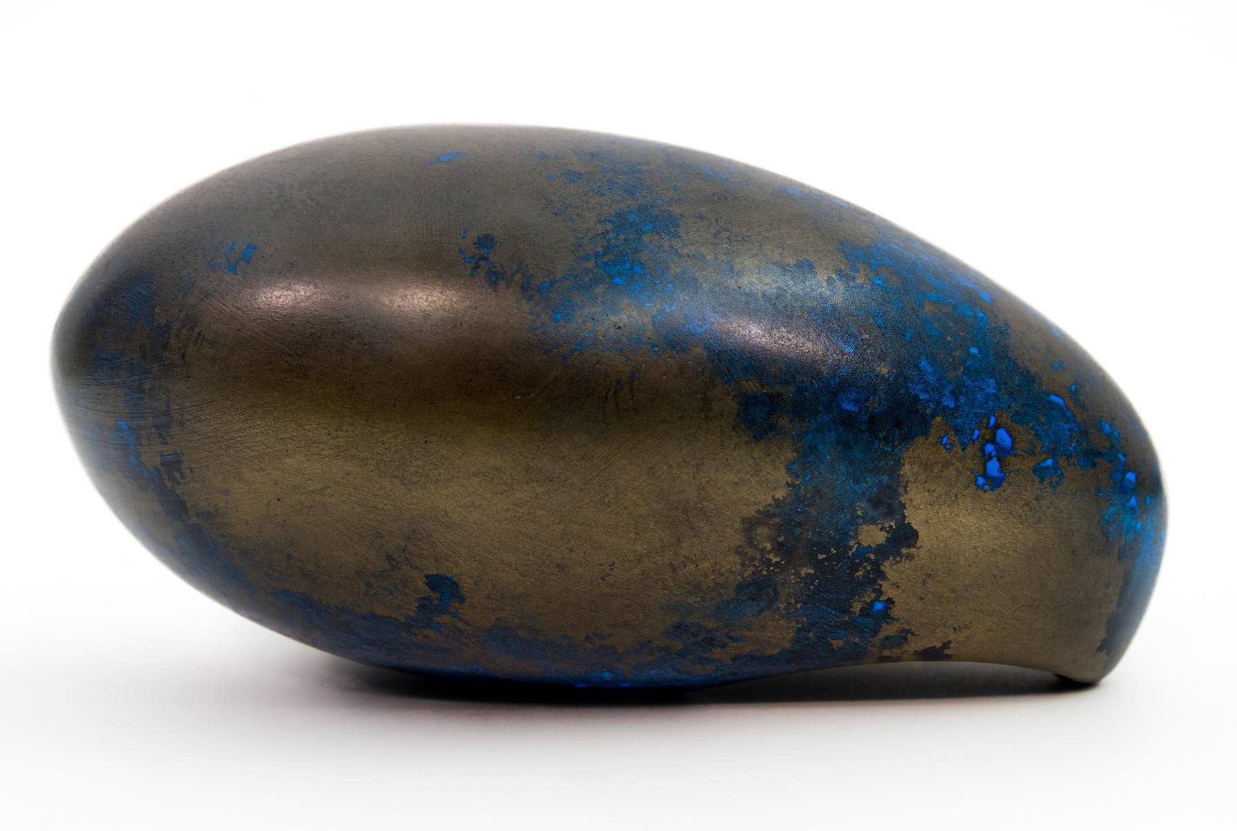 The undulating gentle curves of this sculpture by artist Jana Osterman emulate organic egg shaped forms found in nature. Created out of gypsum, polymer and bronze, the finish is patinated with acid which gives the piece a beautiful deep blue