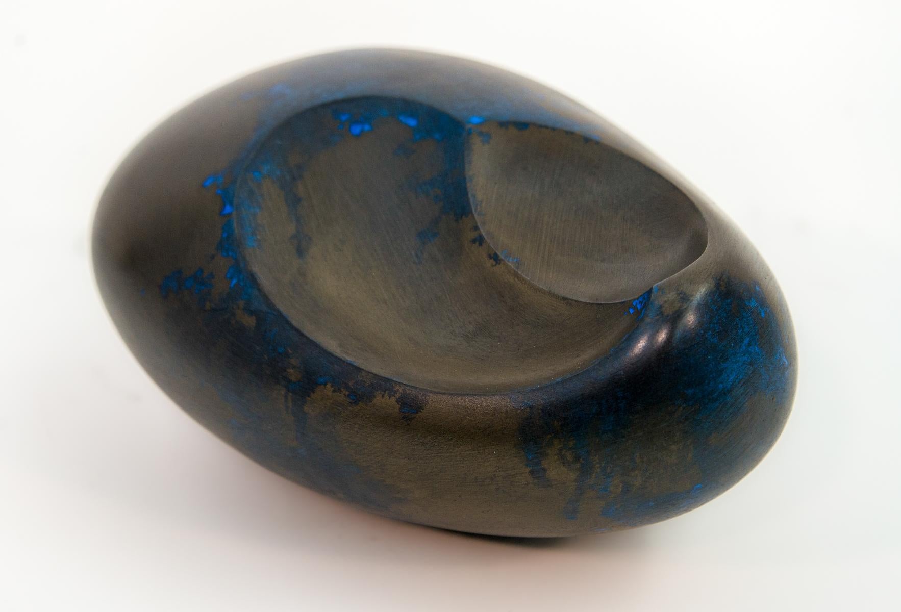 The undulating gentle curves of this sculpture by artist Jana Osterman emulate organic egg shaped forms found in nature. Created out of gypsum, polymer and bronze, the finish is patinated with acid which gives the piece a beautiful deep blue