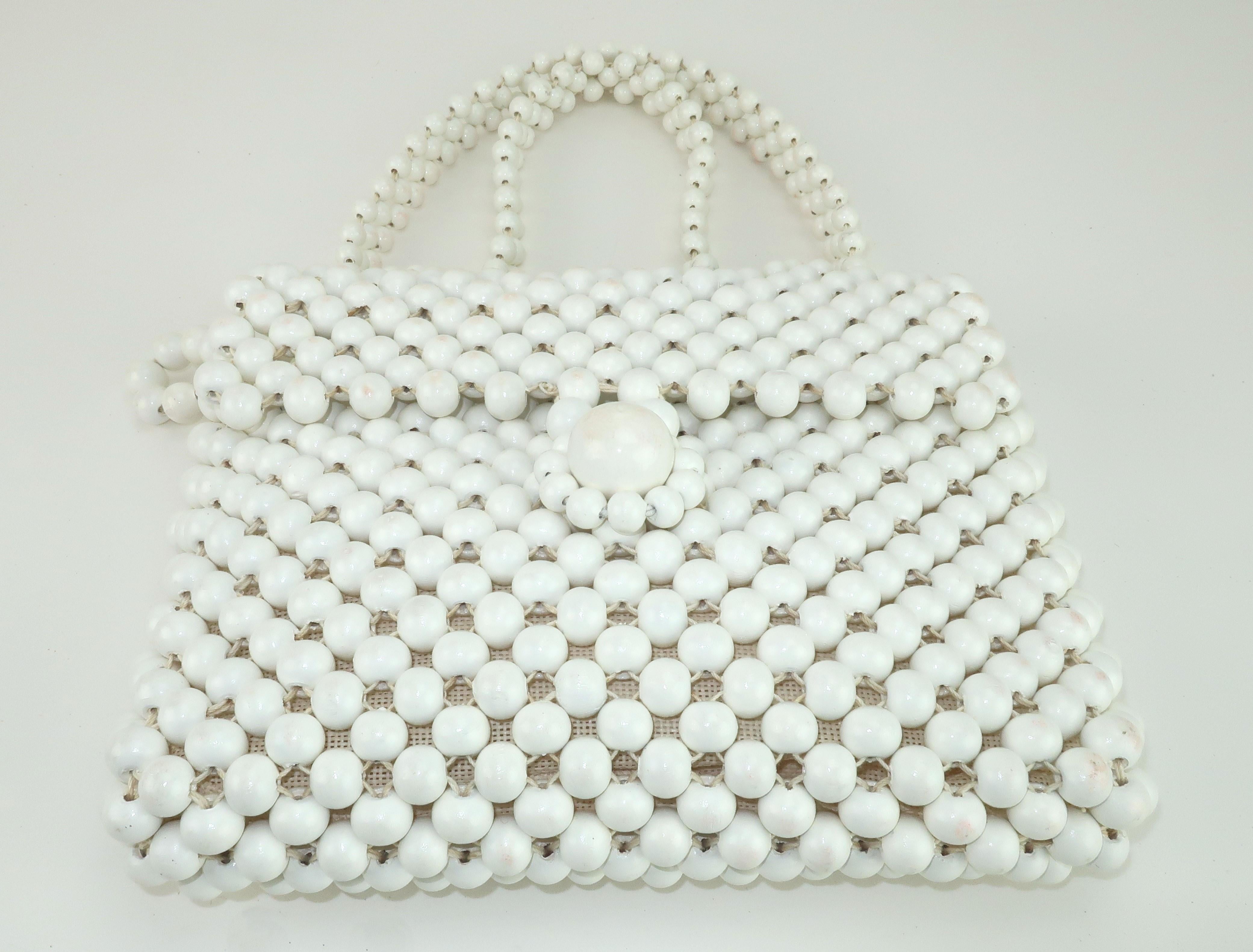 Jana is best known for producing Emilio Pucci's handbags in the 1960's and 1970's.  No doubt they have the 1960's mod style down to a perfect science and this fun handbag is a great example of that look.  The white painted wood beads are woven