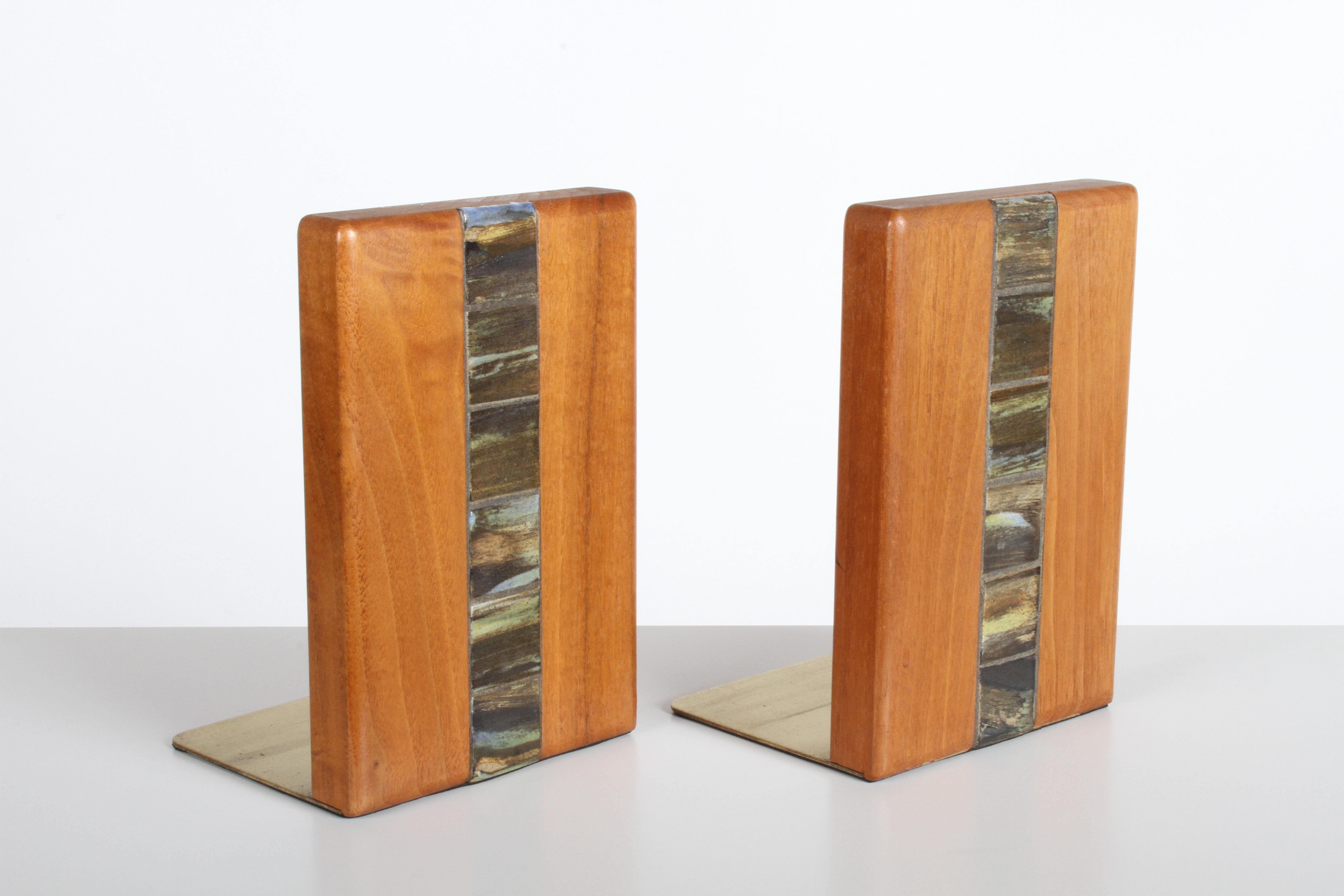 Pair of walnut bookends with inset tiles by Jane and Gordon Martz for Marshall Studios on brass bases. Model number WBER5-132. Very nice original condition, small water spot to one bookend top.
