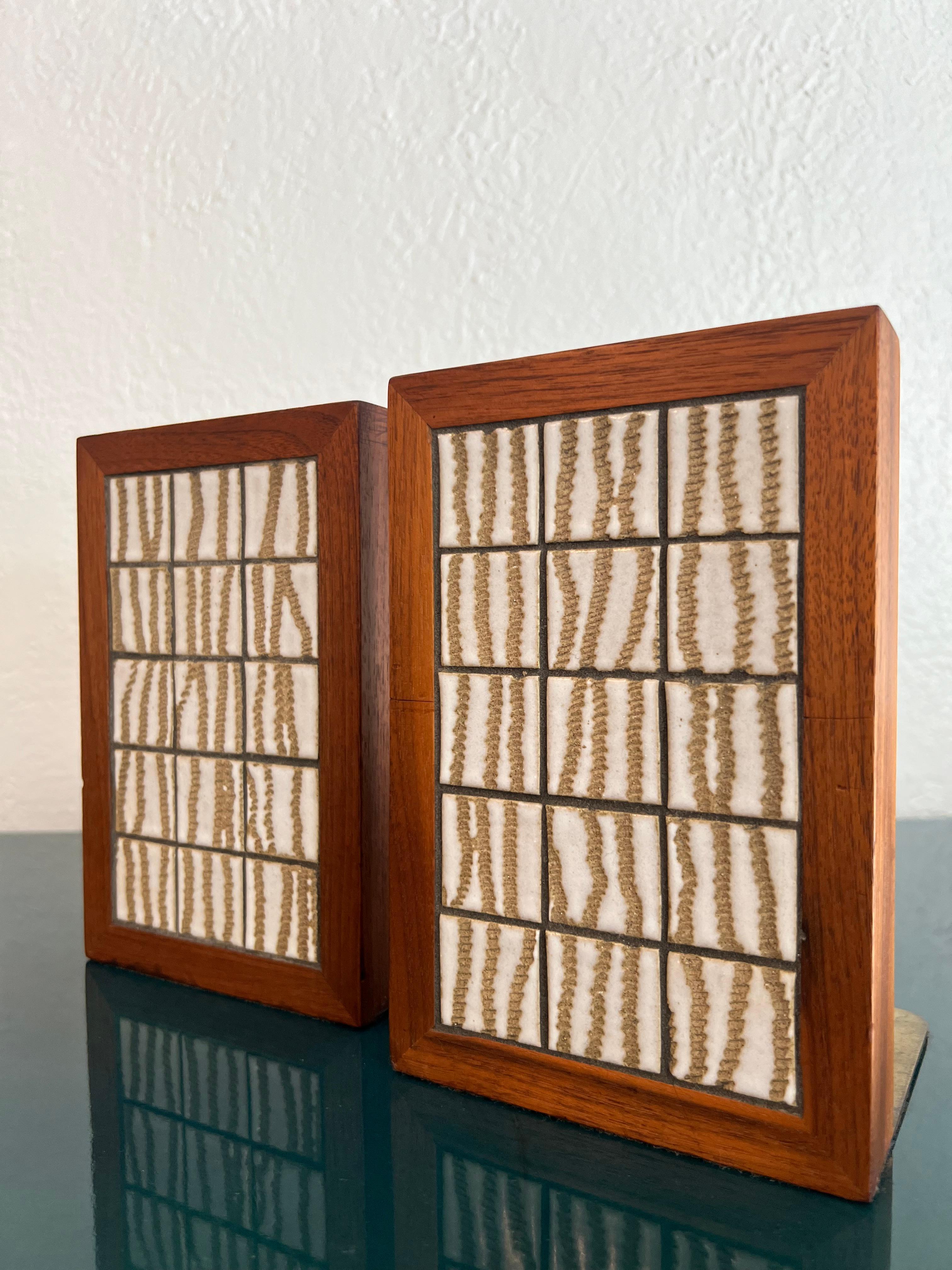 Jane & Gordon Martz walnut and ceramic tile inlaid bookends. Padded backsides for protection. Patina to the brass (please refer to photos). Additional photographs available upon request.

Would work well in a variety of interiors such as modern, mid