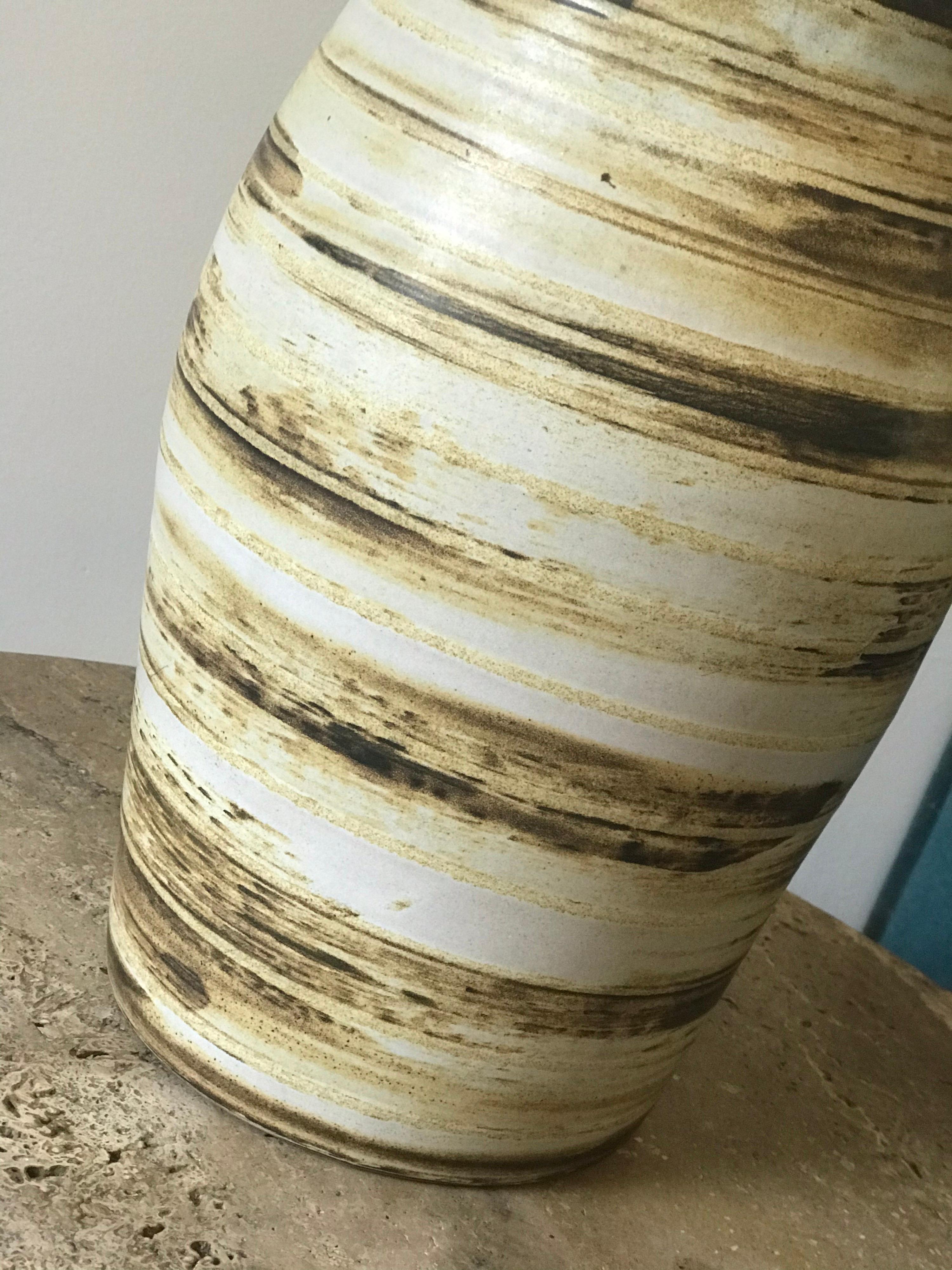 Stunning earth-tone ceramic lamp by Jane and Gordon Martz for Marshall Studios. Beautiful hues to natural hues throughout. New harp and new shade. 


Measures: Overall 26” tall, 15” wide 

Ceramic 13” tall, 7.25” wide.