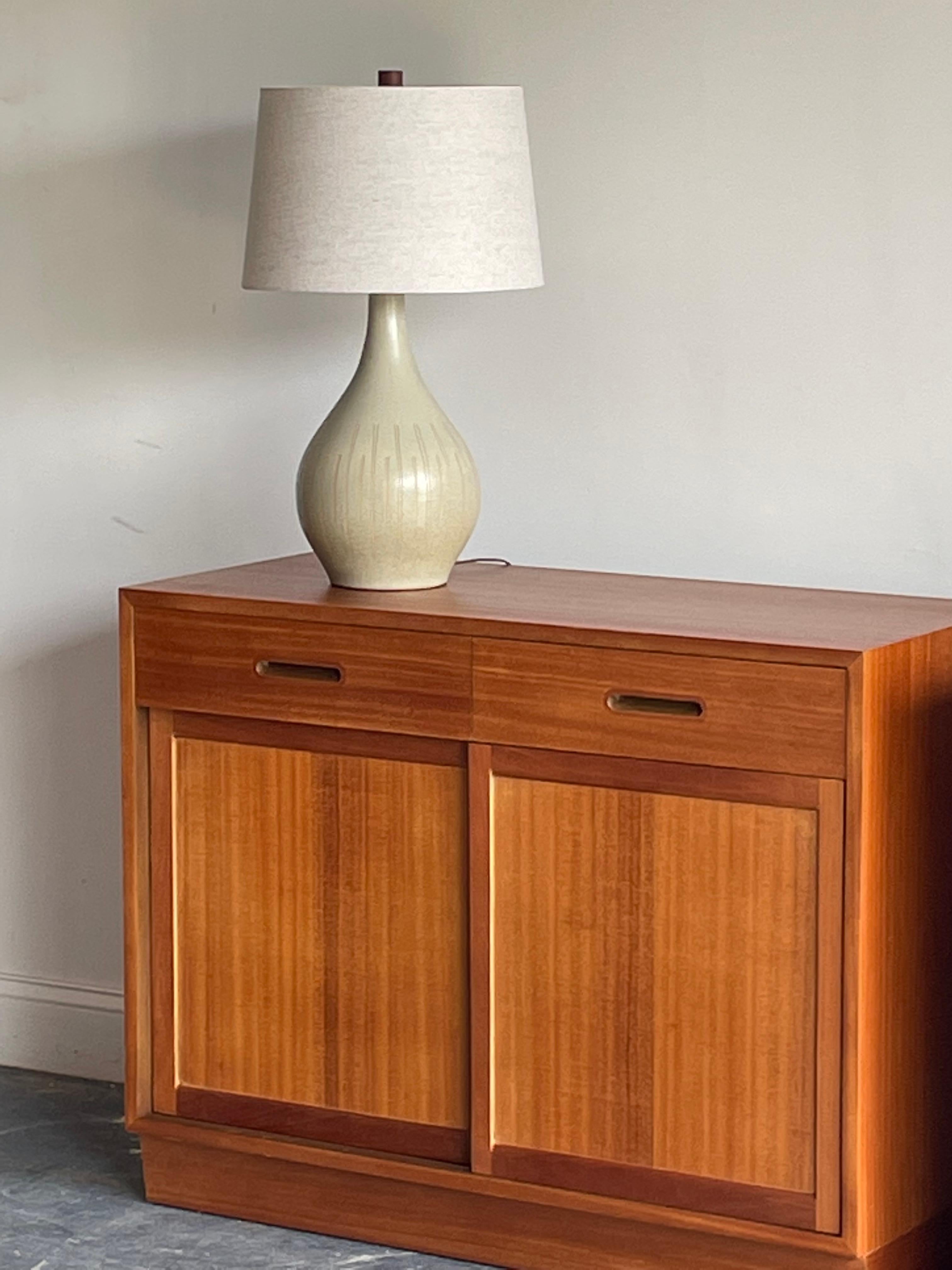 Beautiful table lamp designed by Jane and Gordon Martz for Marshall Studios. Features a flat speckled sea foam glaze with incised details. Wonderful shape and color palette.

Dimensions 
overall:
25.5” tall
15” wide

Ceramic :
15” tall 
9”