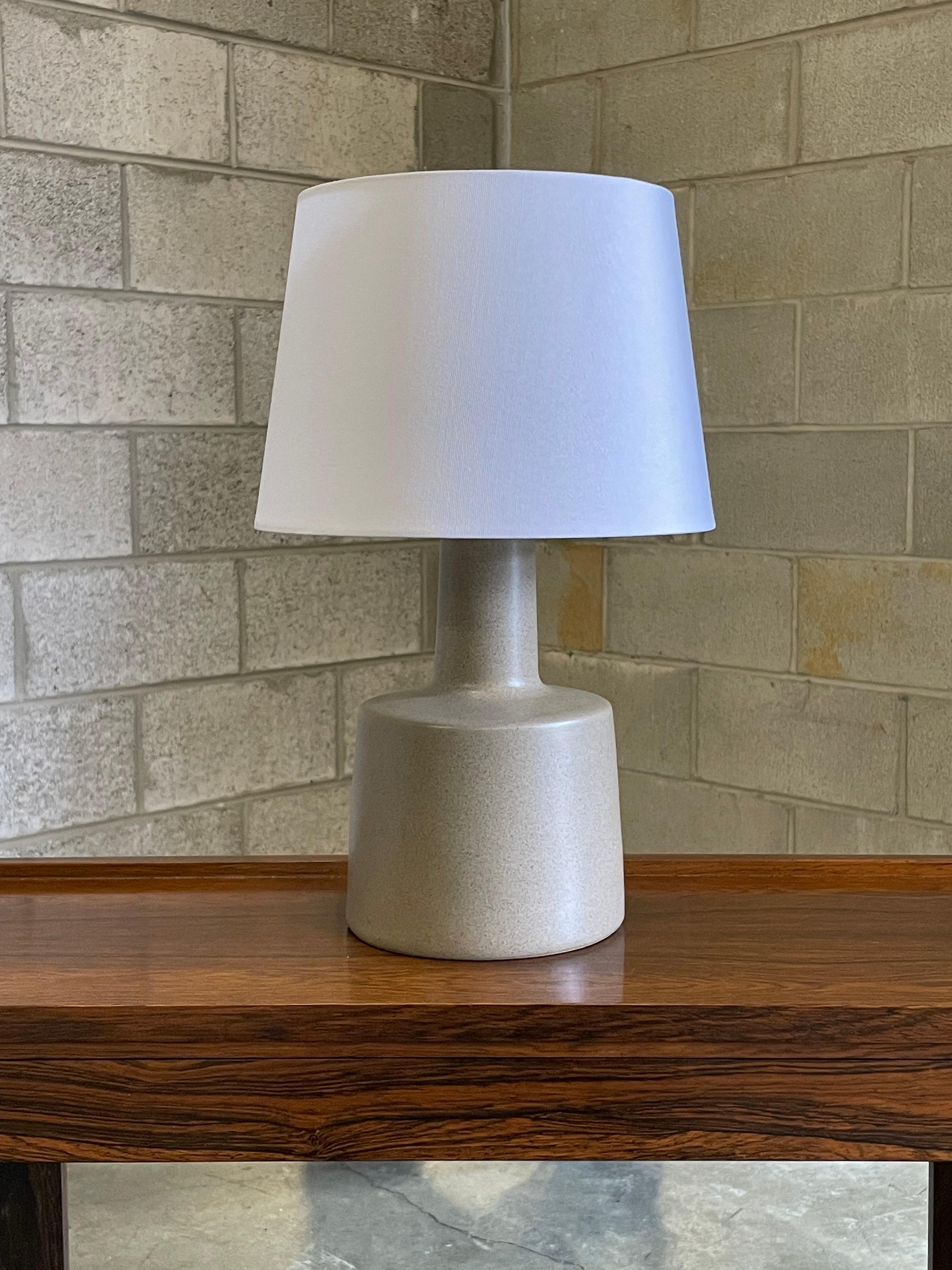 Wonderful beige/ grey ceramic body with blue speckles by famed ceramicist duo Jane and Gordon Martz for Marshall Studios. Great texture, shape, and color. This lamp would work well in a variety of interiors: modern, contemporary, boho chic,