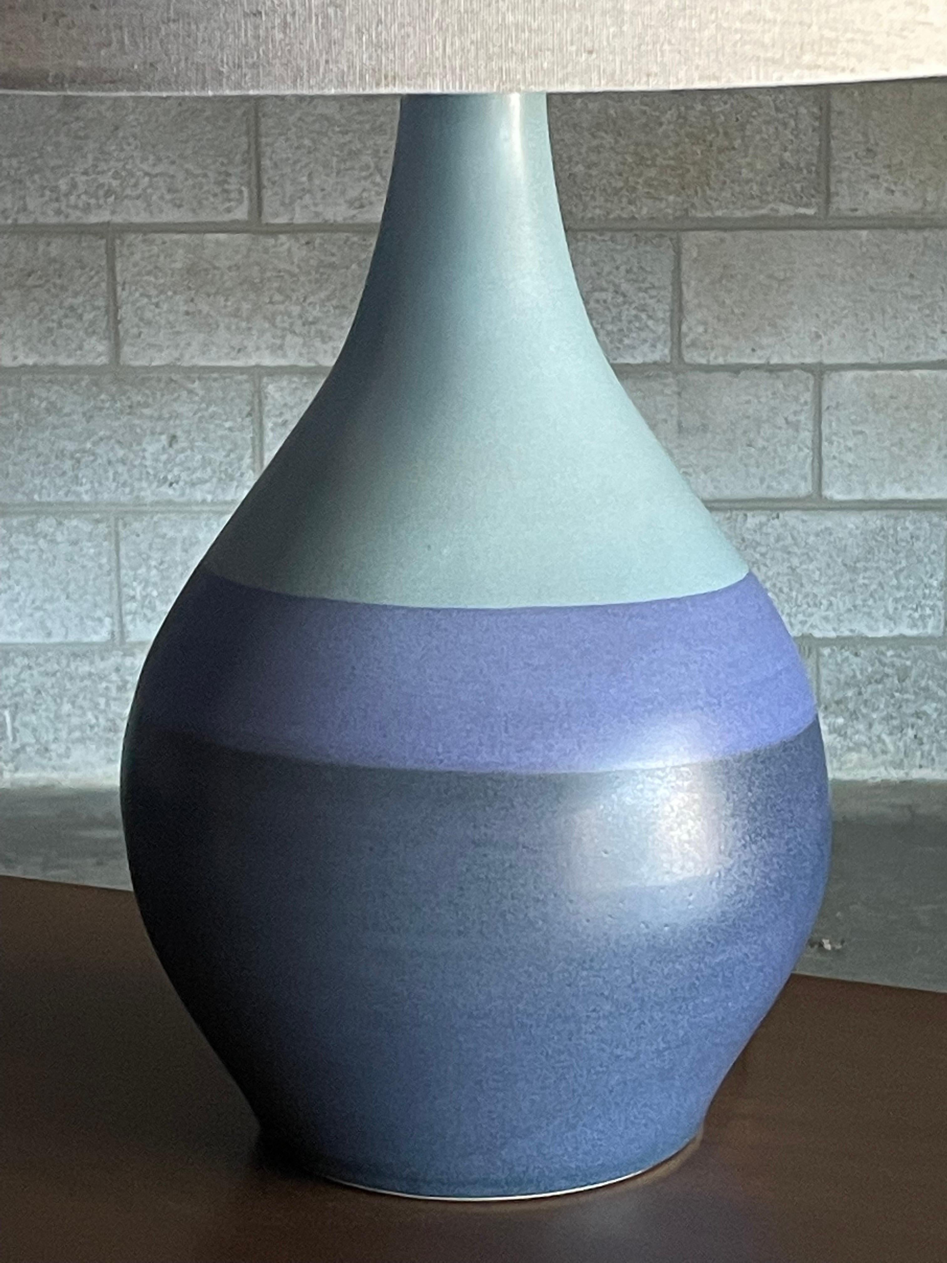 Beautiful table lamp designed by Jane and Gordon Martz for Marshall Studios. Features a flat glaze with blues and a purple hue. Wonderful shape and color palette. 

Dimensions 
overall: 
25.5” tall 
15” wide 

Ceramic : 
15” tall 
9” wide.