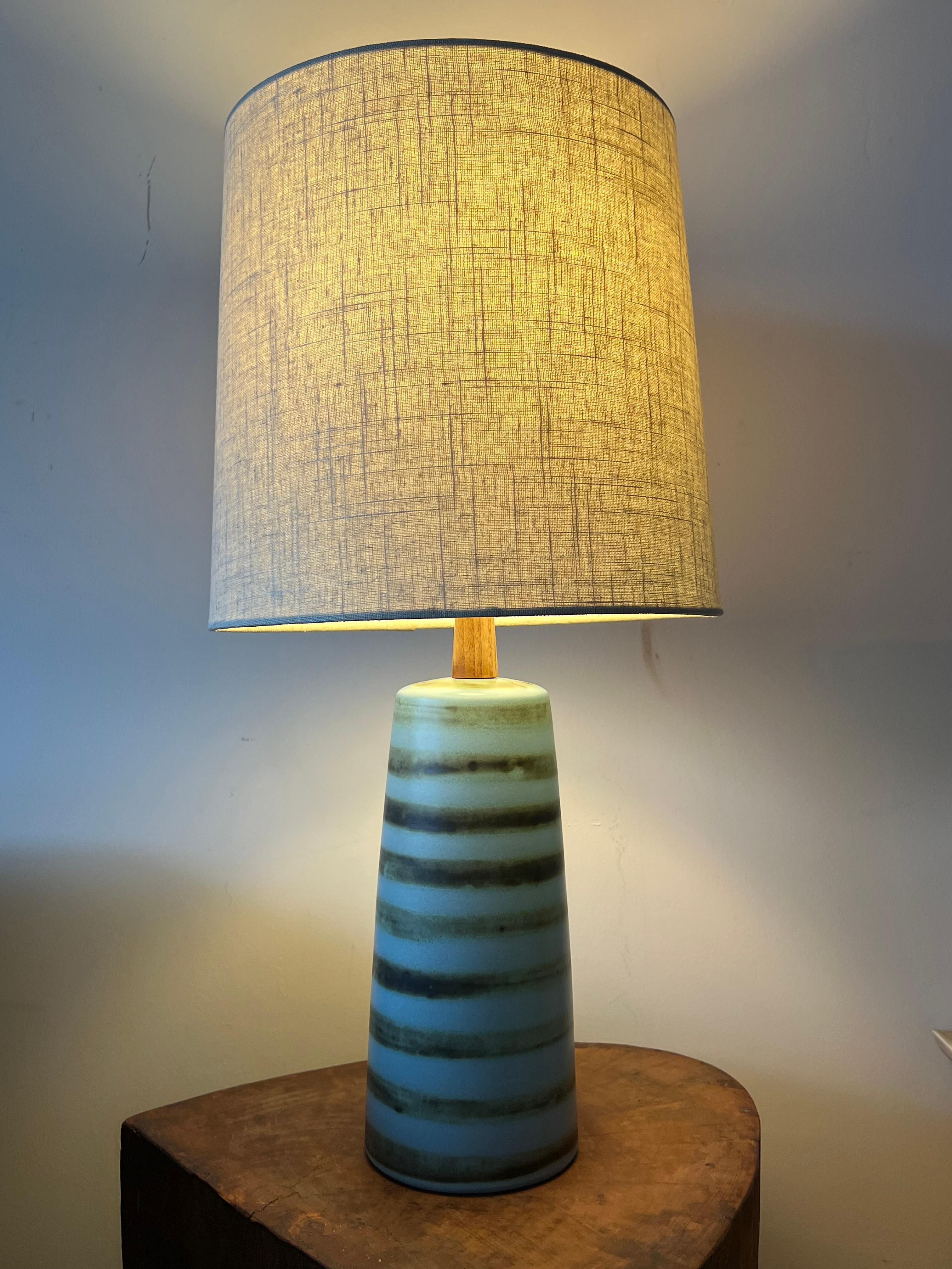 Beautiful table lamp designed by Jane and Gordon Martz for Marshall Studios. Features a flat glaze with brown striping over blue. Wonderful shape and color palette. 

Dimensions 
overall: 
25” tall 
5
