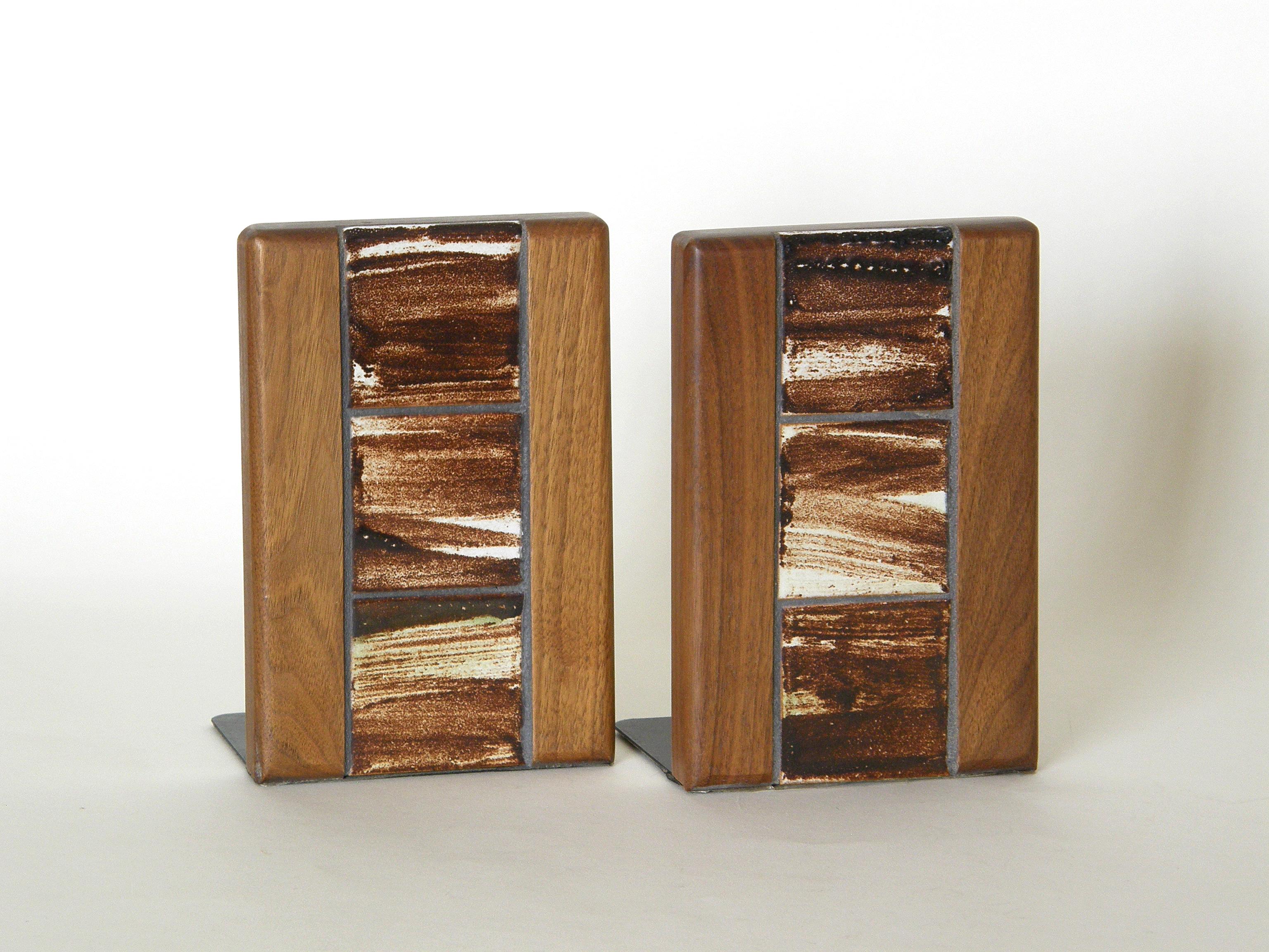 These ceramic tile and walnut bookends were designed and made by Jane and Gordon Martz for Marshall Studios. The rectangular forms are softened by the loose brush strokes in the glaze and the grain in the wood. The two materials complement each