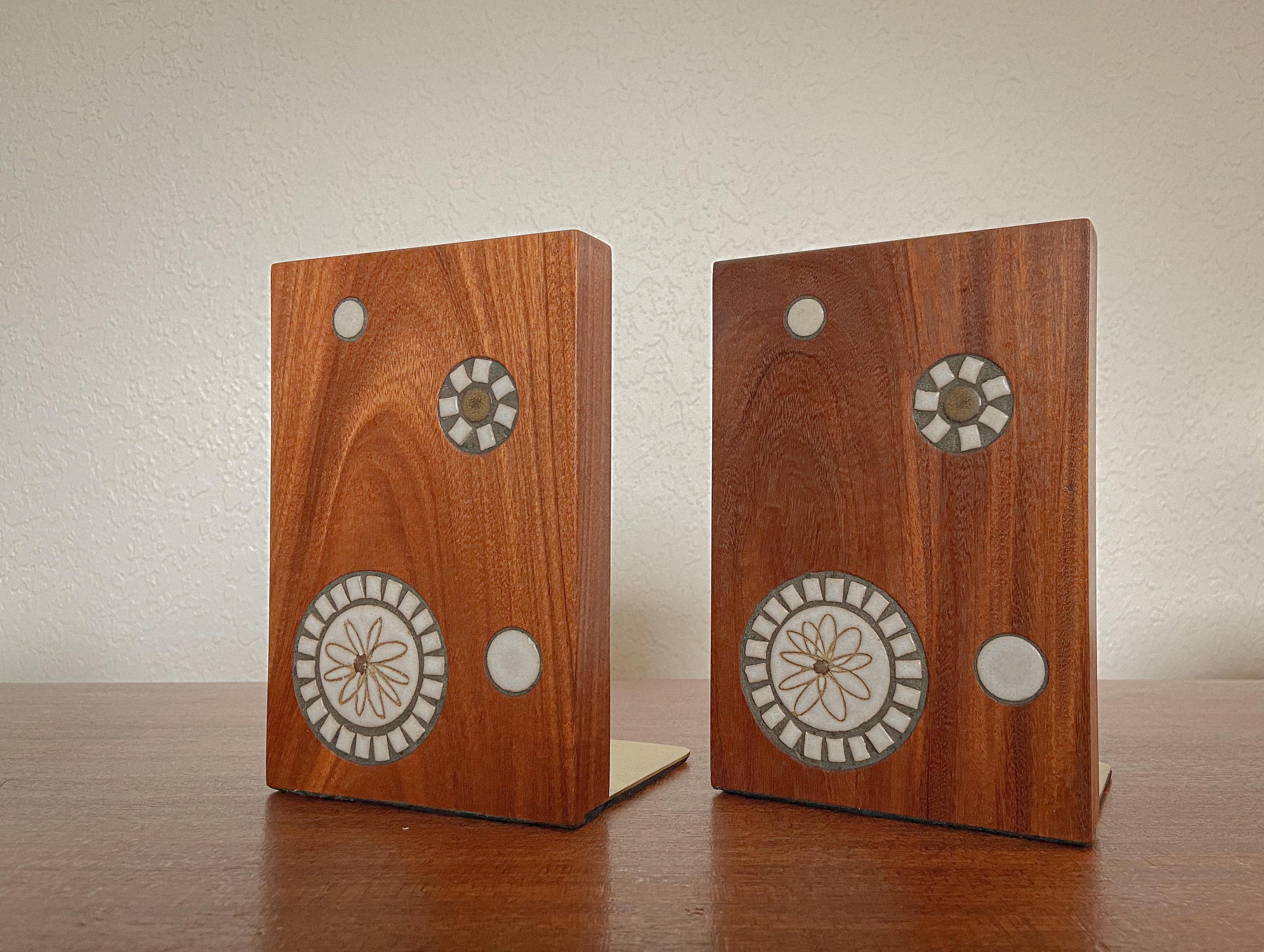 A unique and wonderful set of bookends designed by Gordon and Jane Martz for Marshall Studios. These feature solid walnut bodies inlaid with handmade glazed ceramic tiles, These are a bit unique because they feature a sgraffito pattern on the