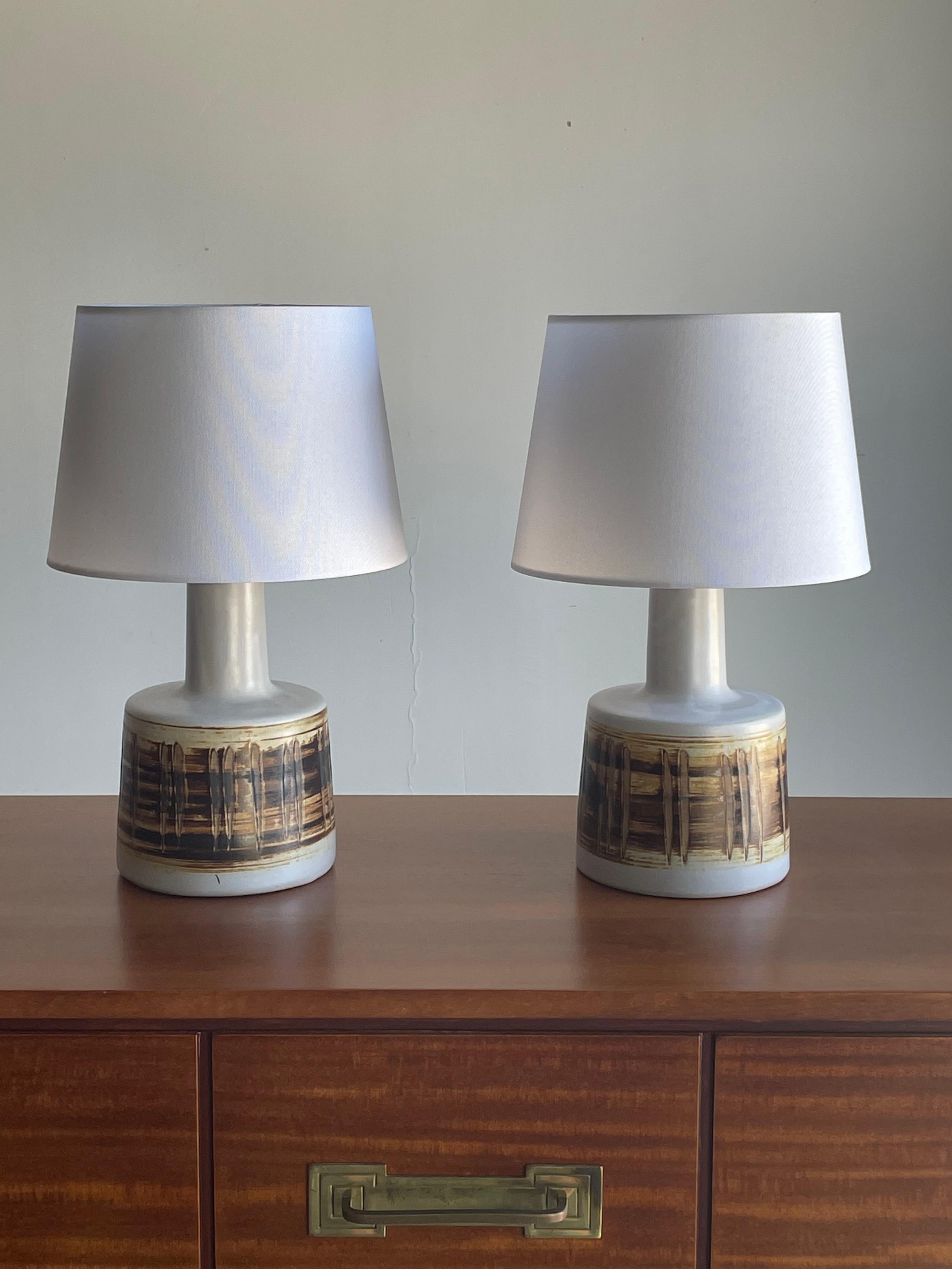 Pair of table lamps by famed ceramicist duo Jane and Gordon Martz for Marshall Studios. Yellow and brown color palette to the ceramic body.

Martz pair 
Overall
16” tall 
10” wide.

Ceramic 
9.25” tall
6” wide