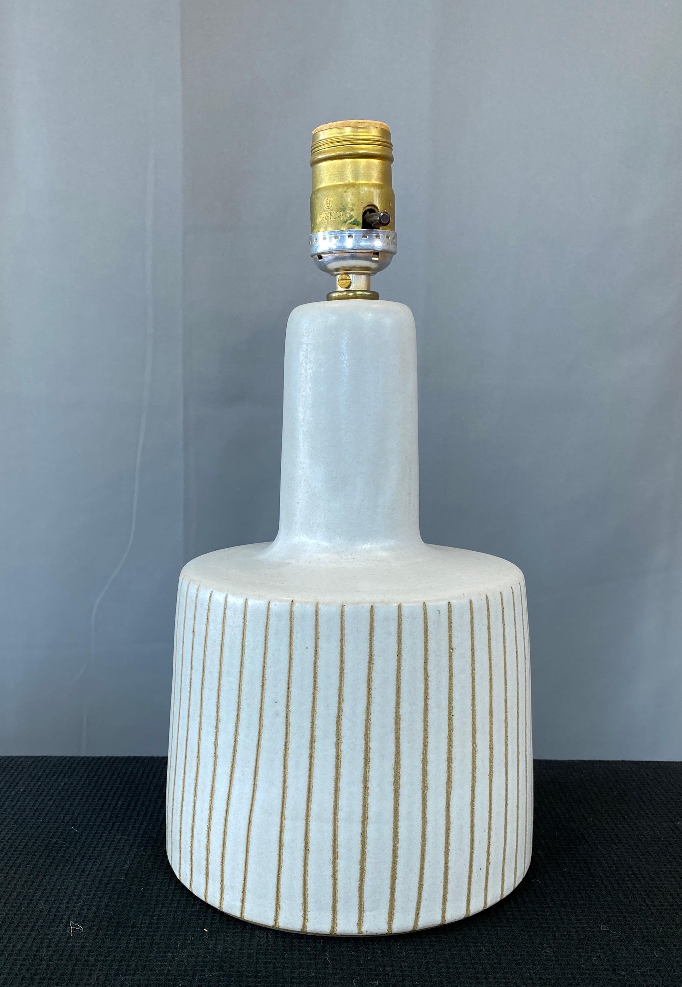 A Jane and Gordon Martz for Marshall Studios, small ceramic table lamp. 
In dove grey with incised lines around it's sides. Signed on it's back side. 

Lamp base it's self is 9 1/4 inch high.