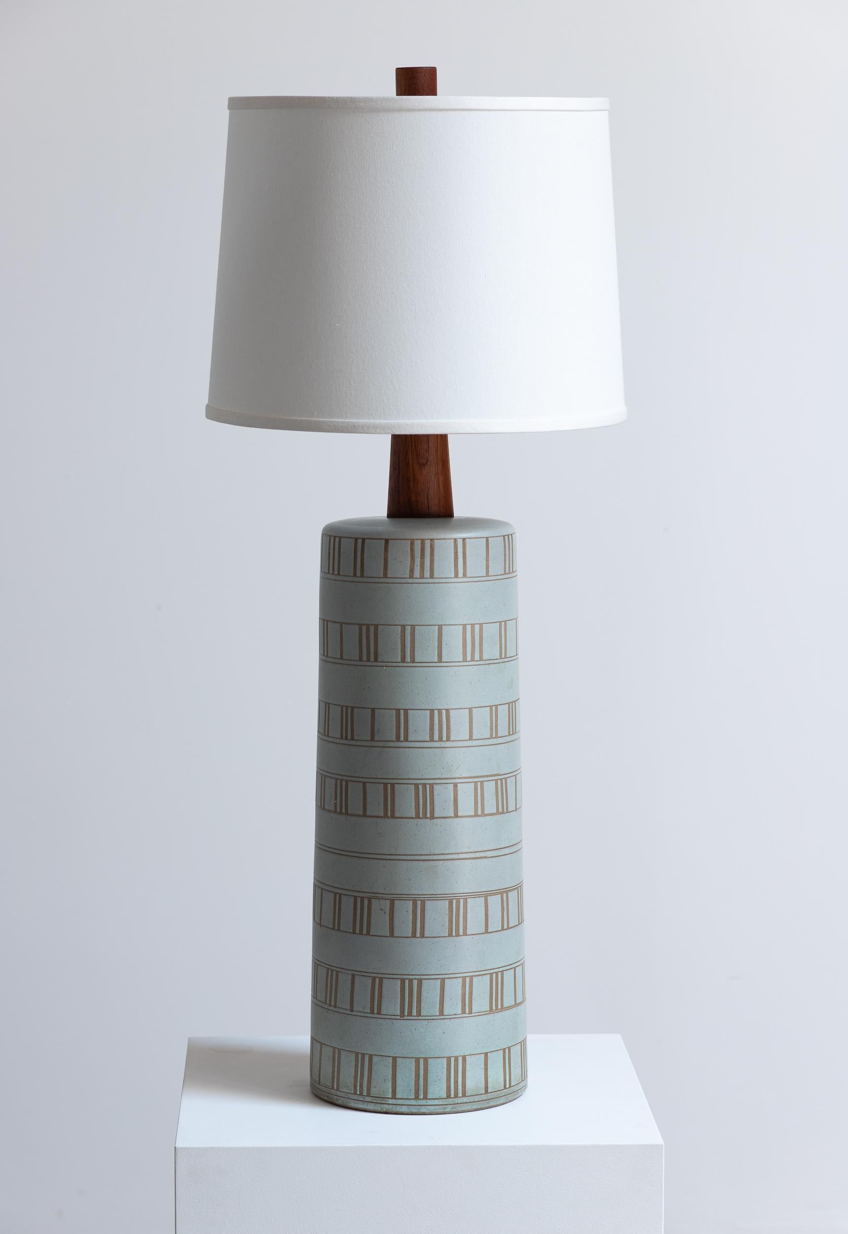 Monumental ceramic table lamp, designed by Jane and Gordon Martz for Marshall Studios. This exquisite piece showcases the designers' exceptional craftsmanship in both ceramic and wood. The lamp features a finely crafted ceramic base with a subtle,